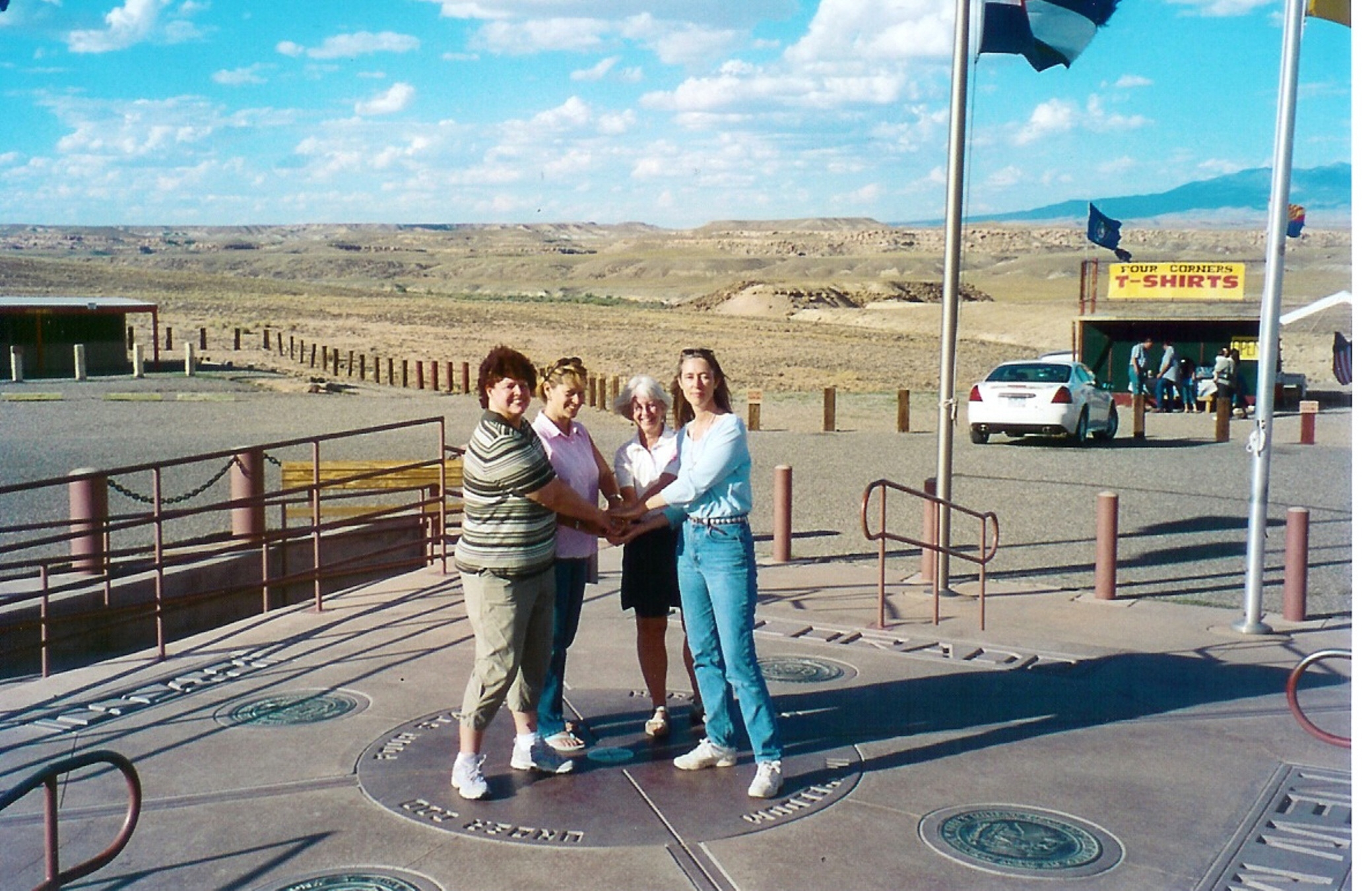 Travelers meeting across the four state markers at Four Corners Monument
