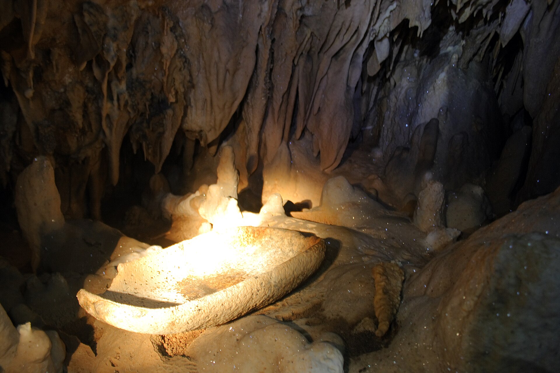 Maya pottery among limestone formations in Actun Tunichil Muknal cave