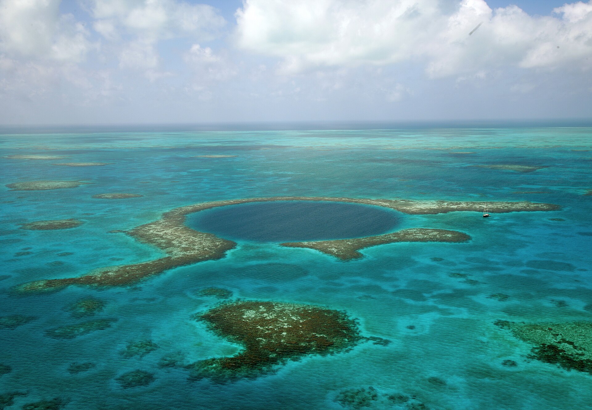 The Great Blue Hole ringed by coral in the Belize Barrier Reef