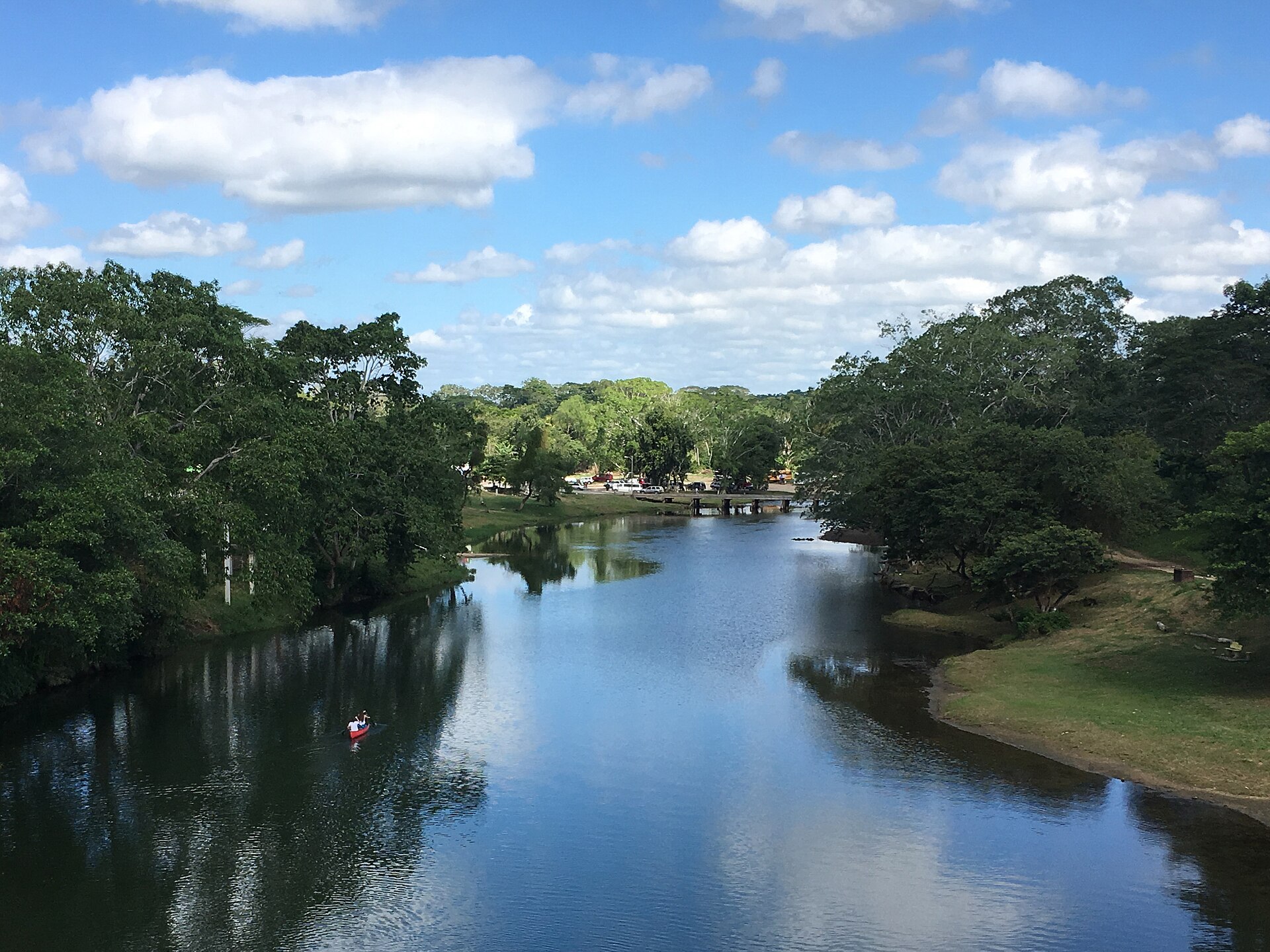 A canoe on the forested Macal River at San Ignacio, Belize