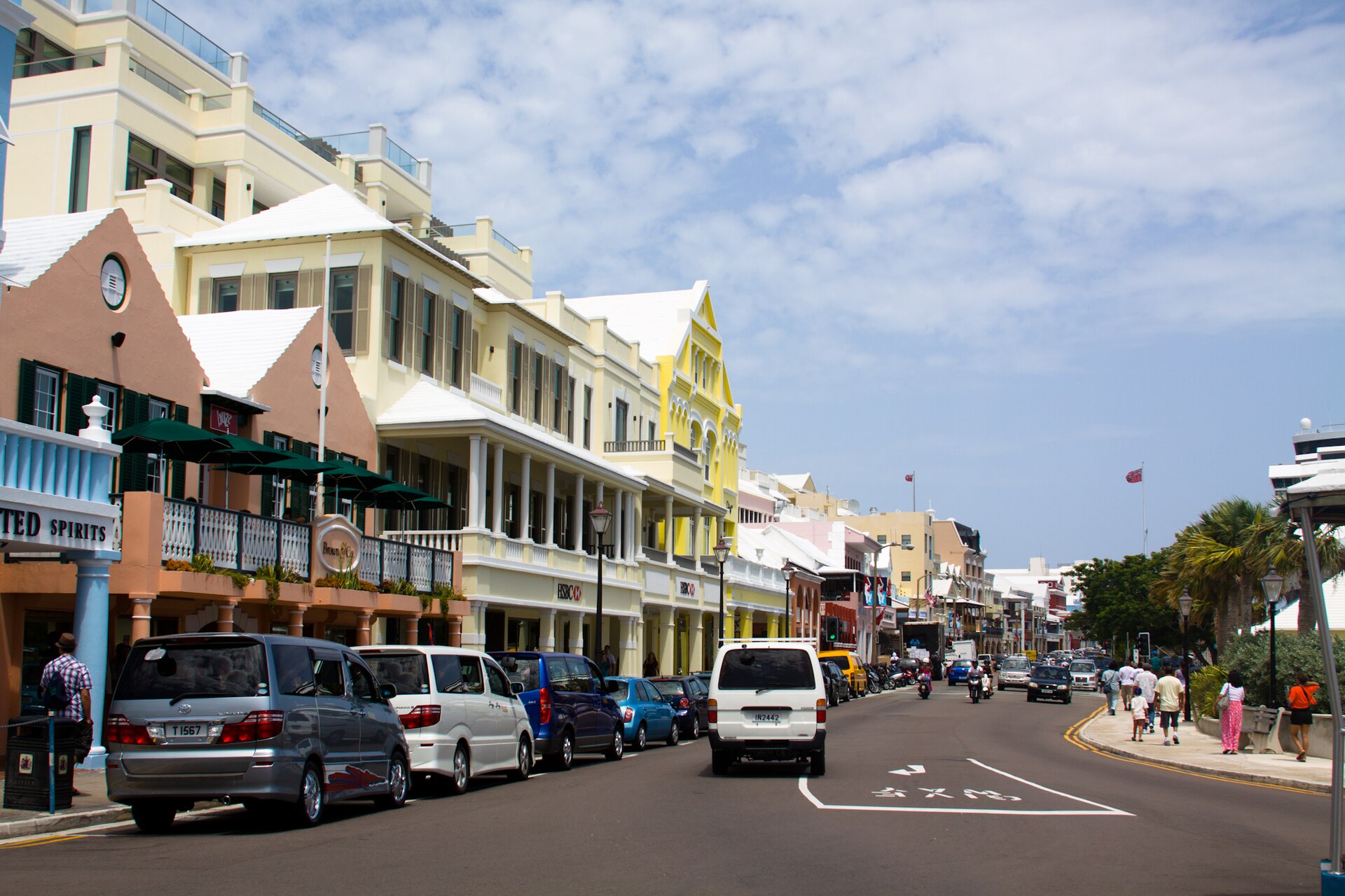 Pastel storefronts, pedestrians, and street life along Front Street in Hamilton, Bermuda
