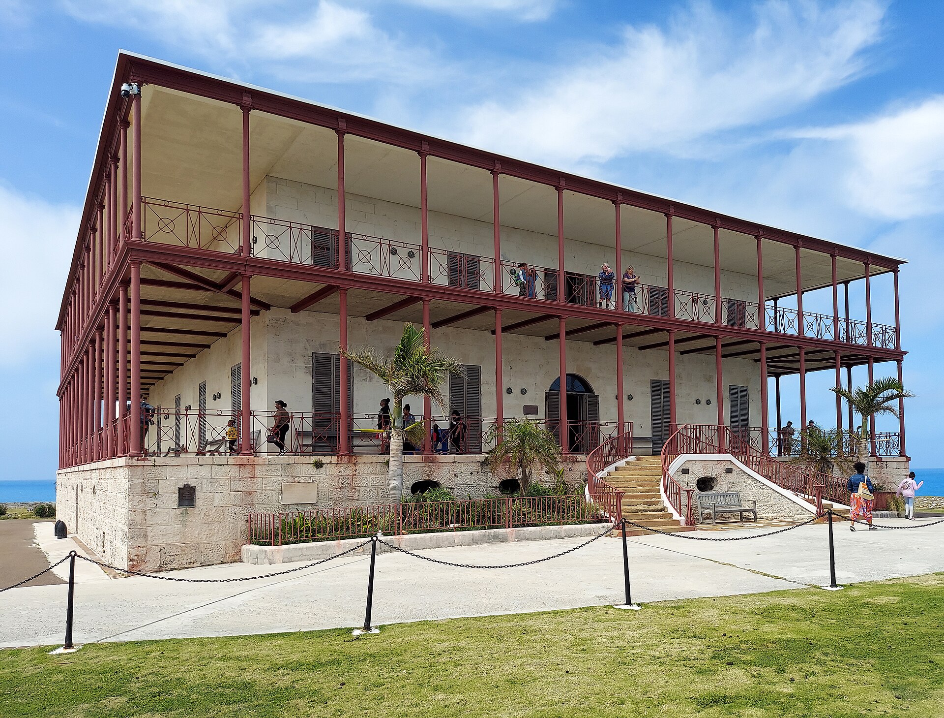 The Commissioner's House at Bermuda's Royal Naval Dockyard with visitors on its verandas