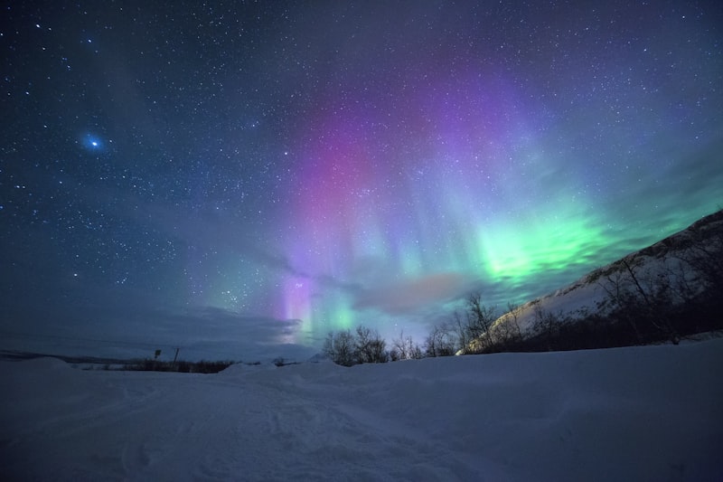 Aurora above a snowy Arctic landscape representing winter Norway