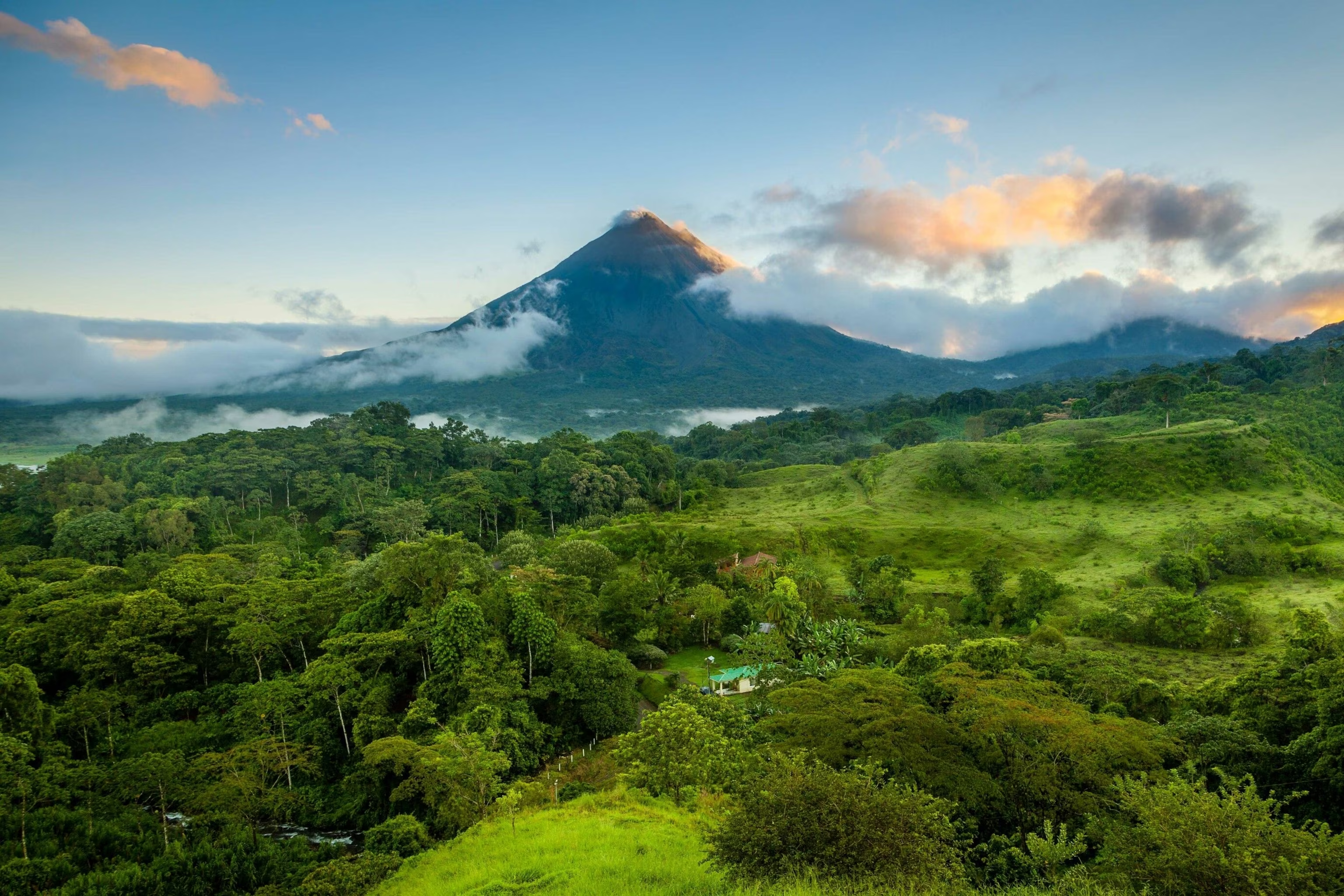 Costa Rica volcano rising above lush rainforest