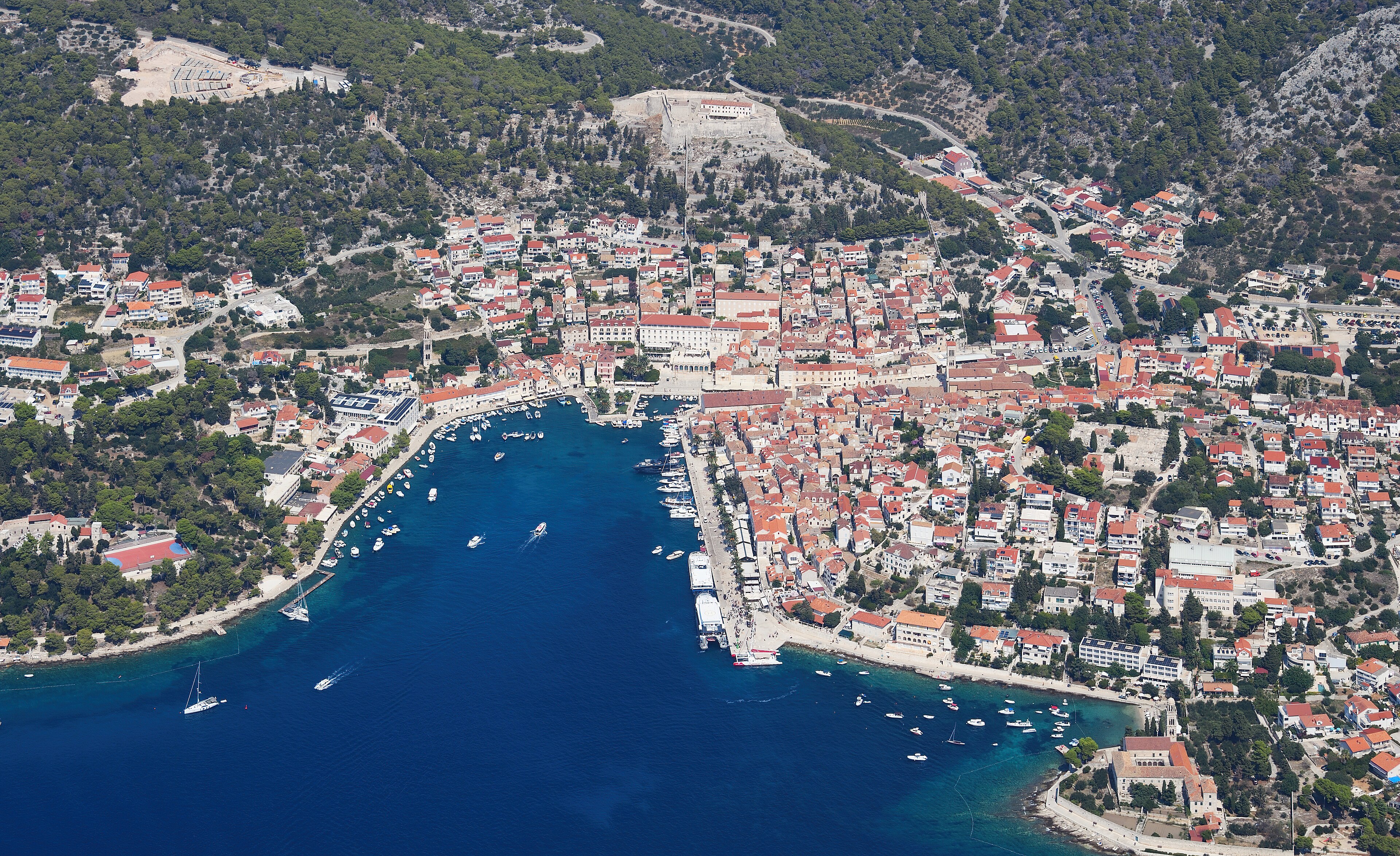 Aerial view of Hvar Town, its harbor, fortress, and Adriatic island setting in Croatia