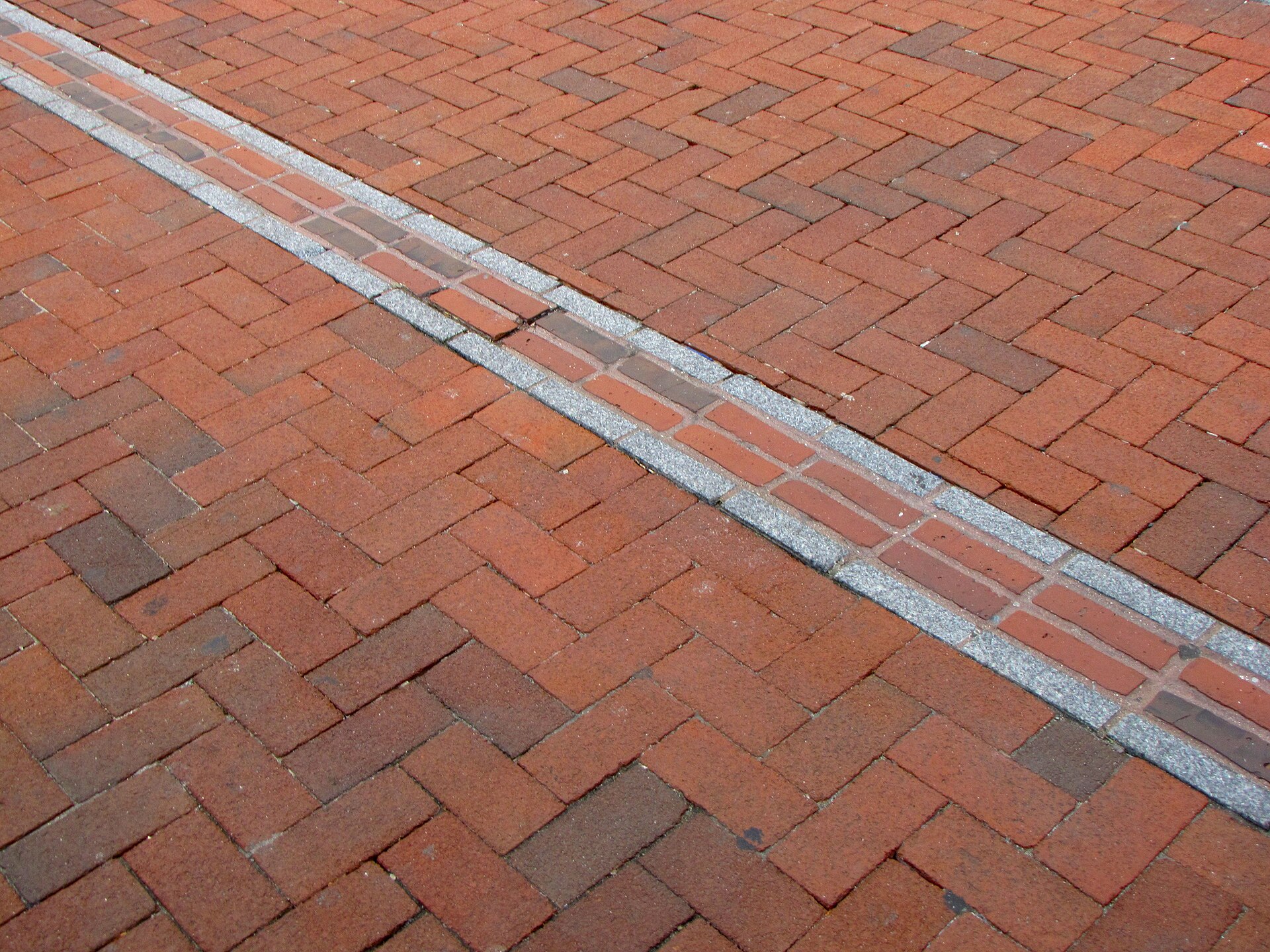 Red-brick Freedom Trail path threading through a Boston streetscape