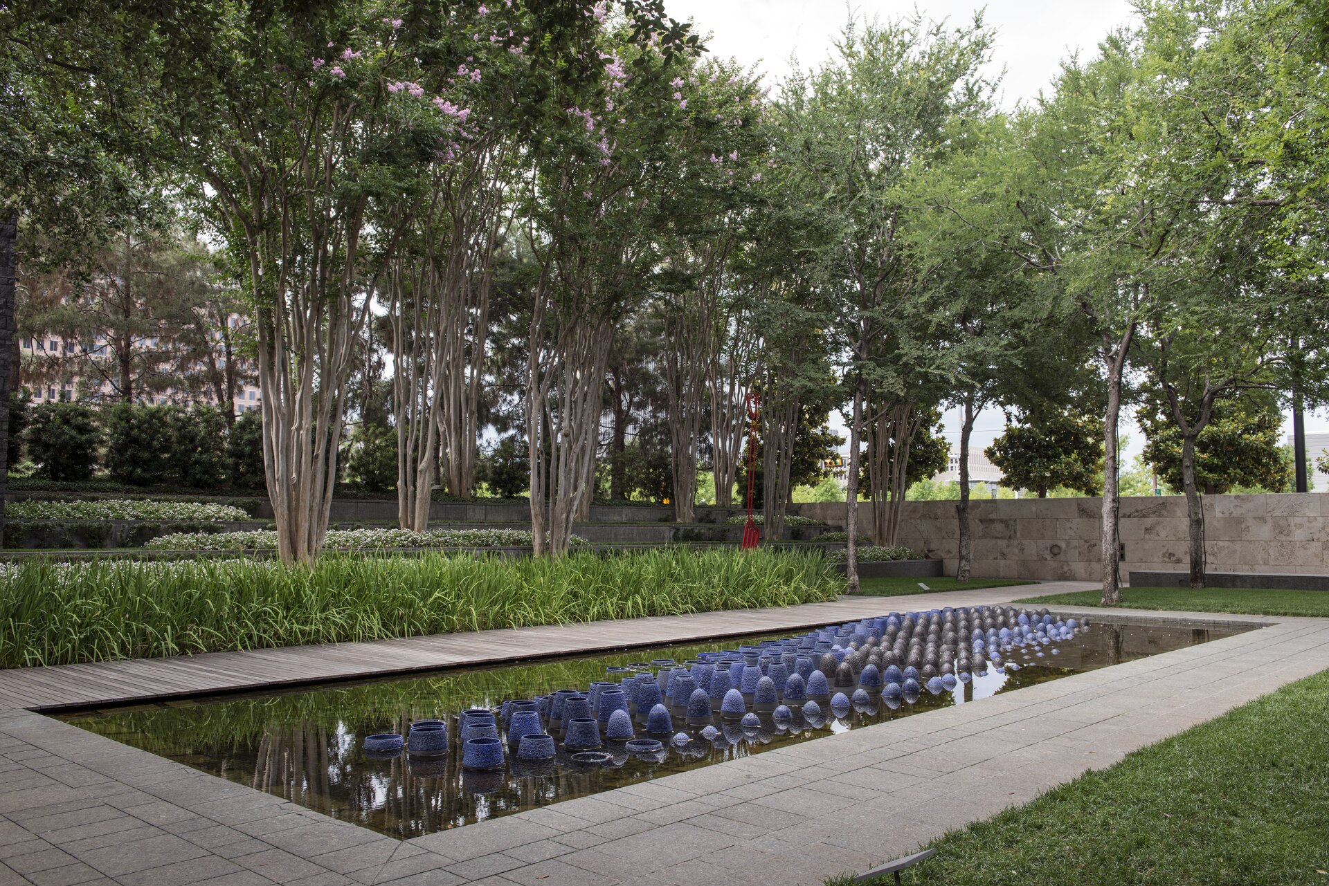 Visitors among contemporary sculpture and greenery at Dallas's Nasher Sculpture Center
