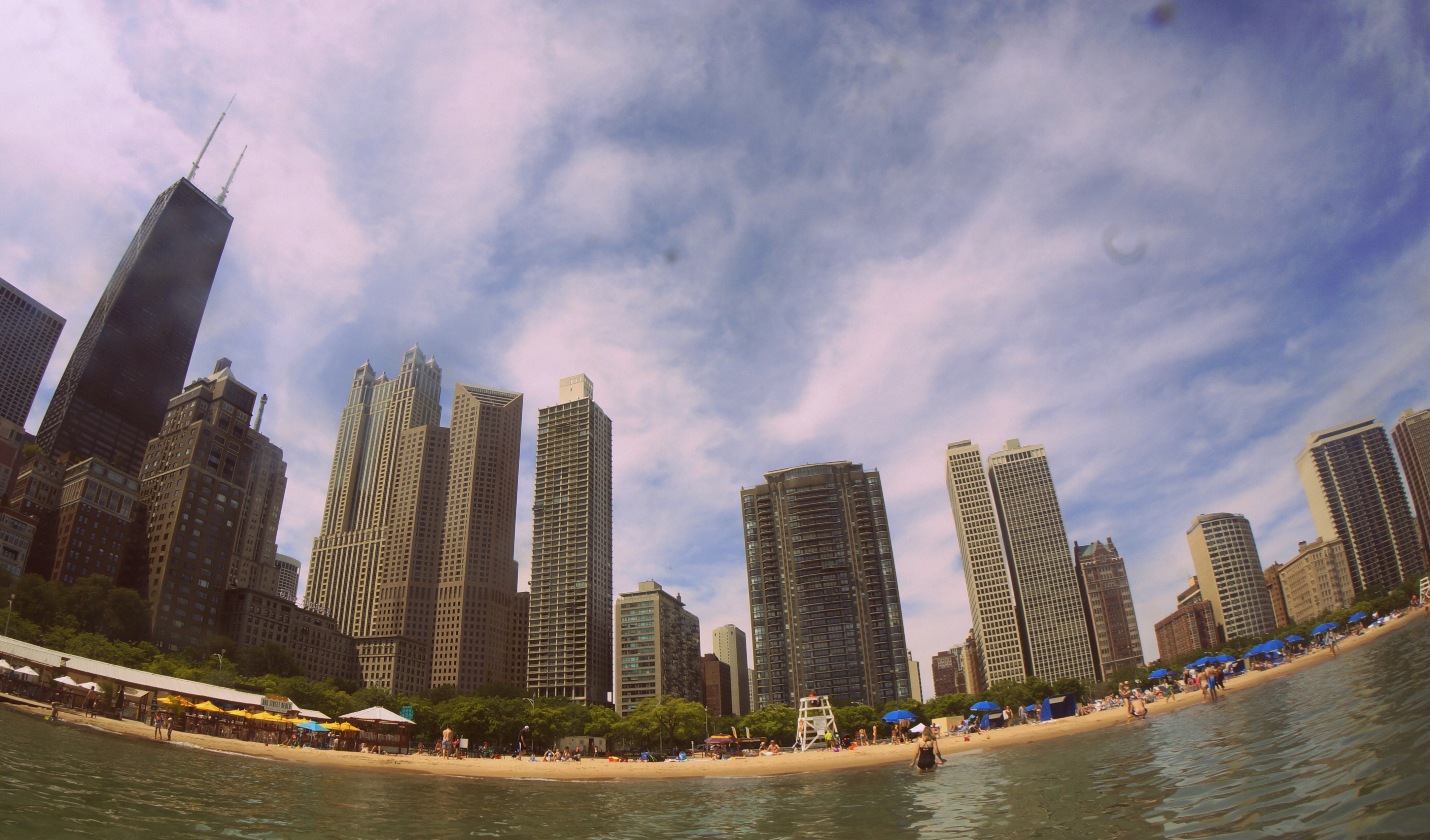 Chicago towers and a busy Lake Michigan beach share one shoreline