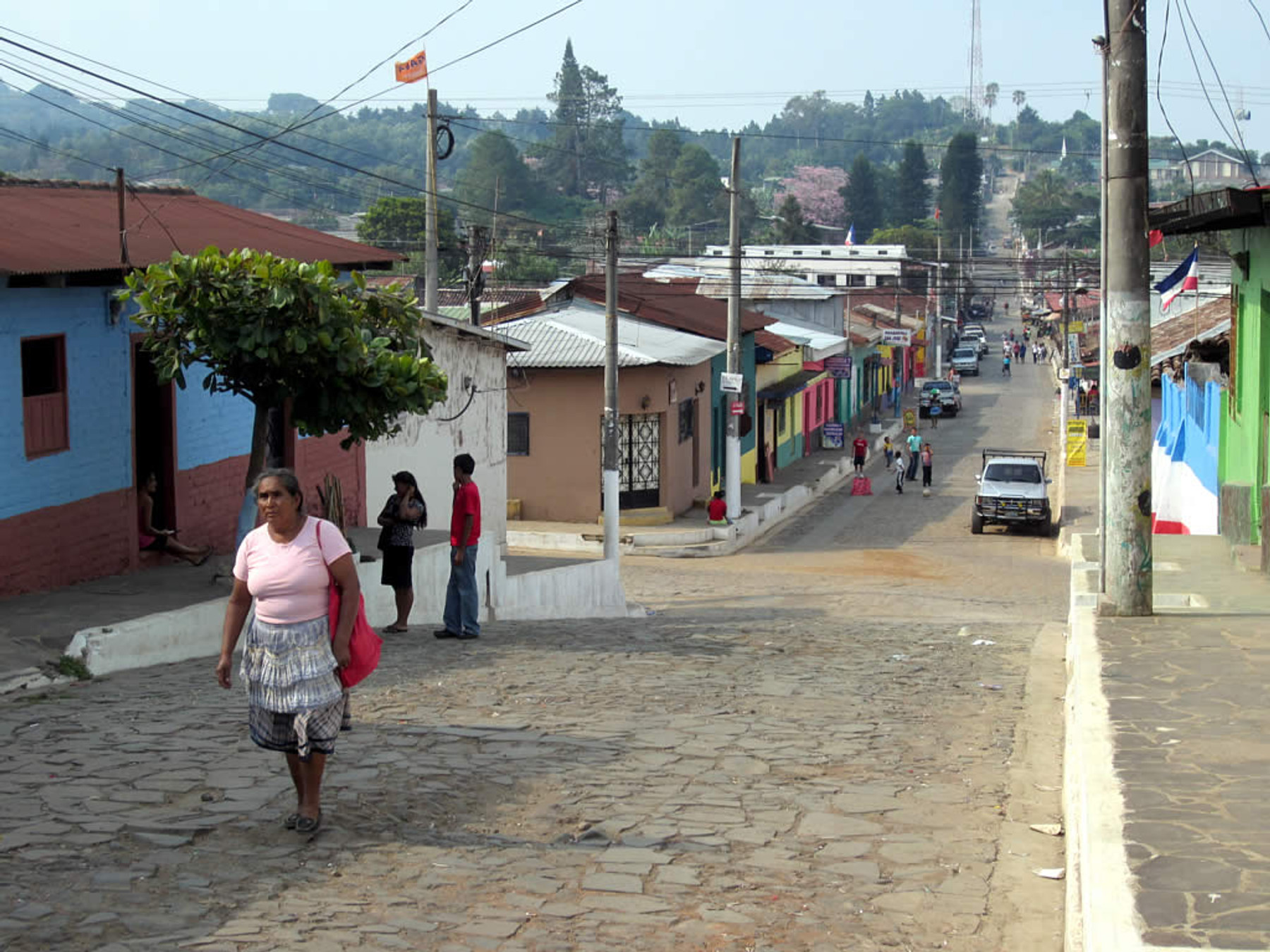 Residents walking along a colorful street in Ataco on El Salvador's Ruta de las Flores