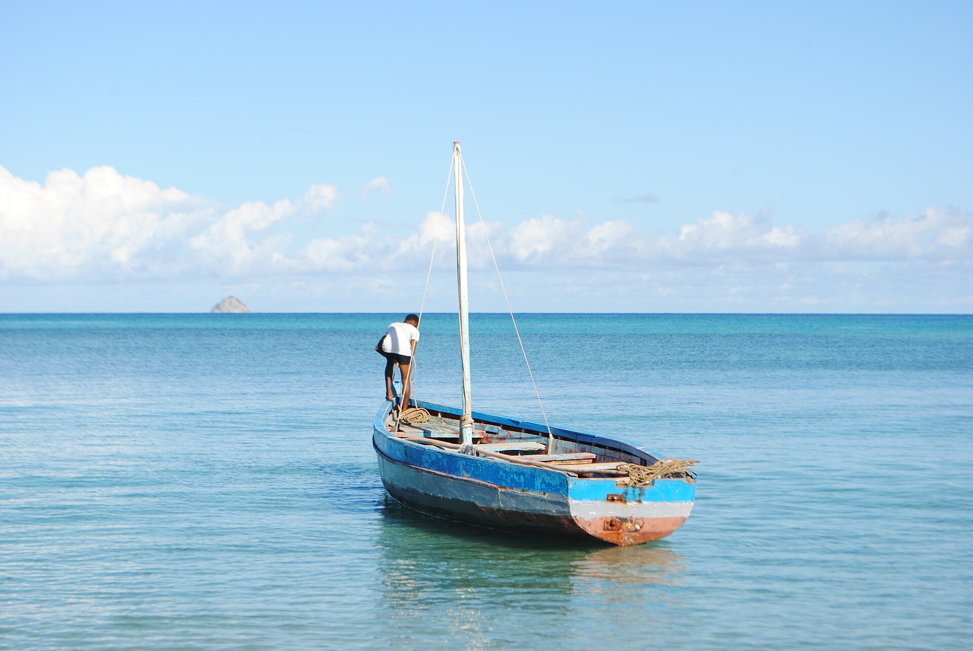 A fisherman and traditional boat off Nosy Be, Madagascar