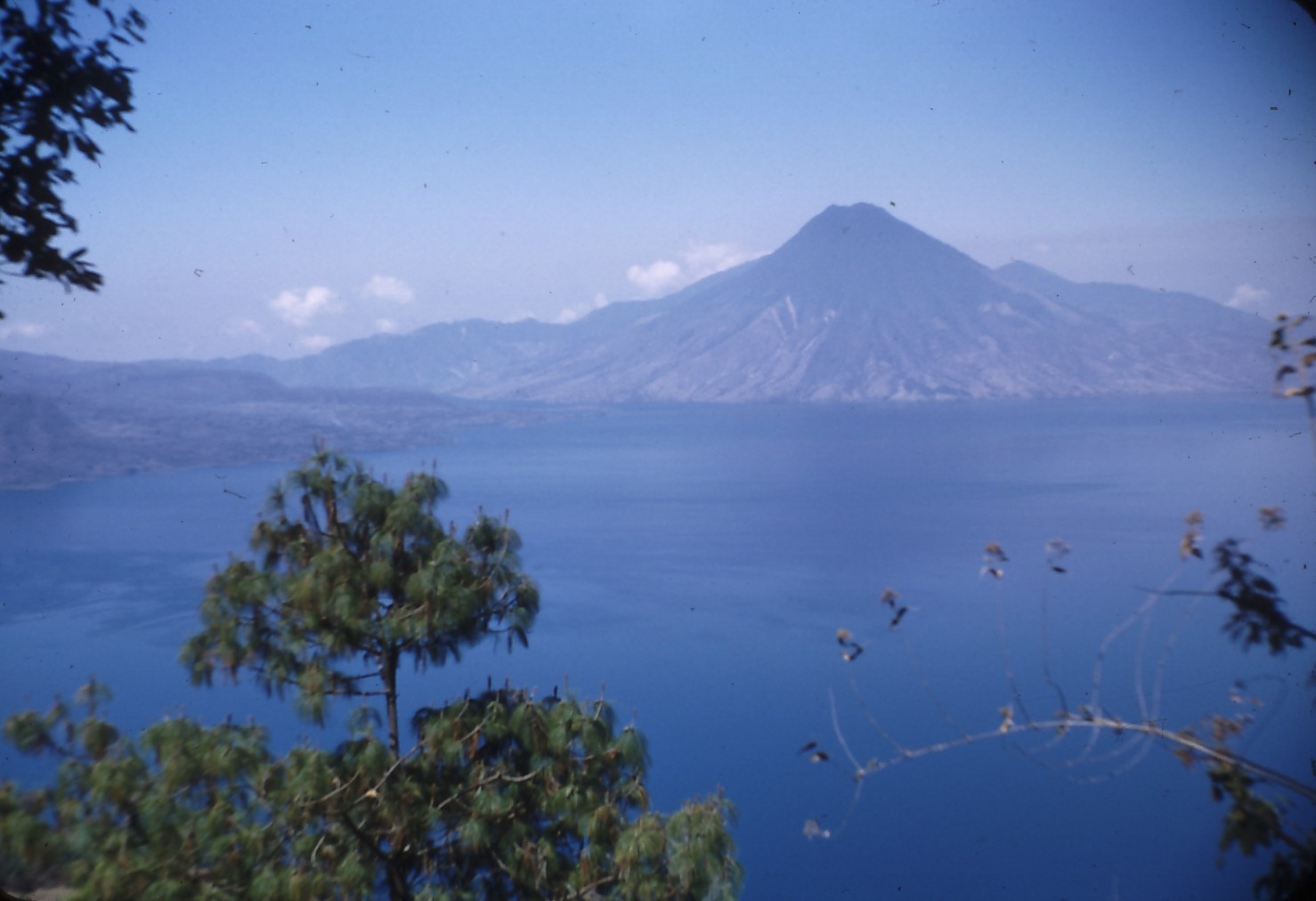 Lake Atitlán and its volcanoes viewed across a highland shoreline