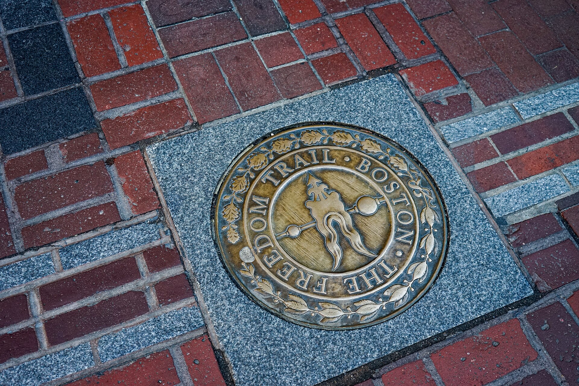 Bronze Freedom Trail medallion set into Boston's red-brick pavement