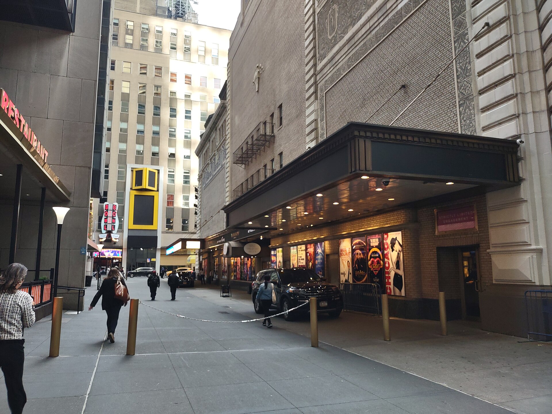 Shubert Alley lined with Broadway theater marquees and production posters
