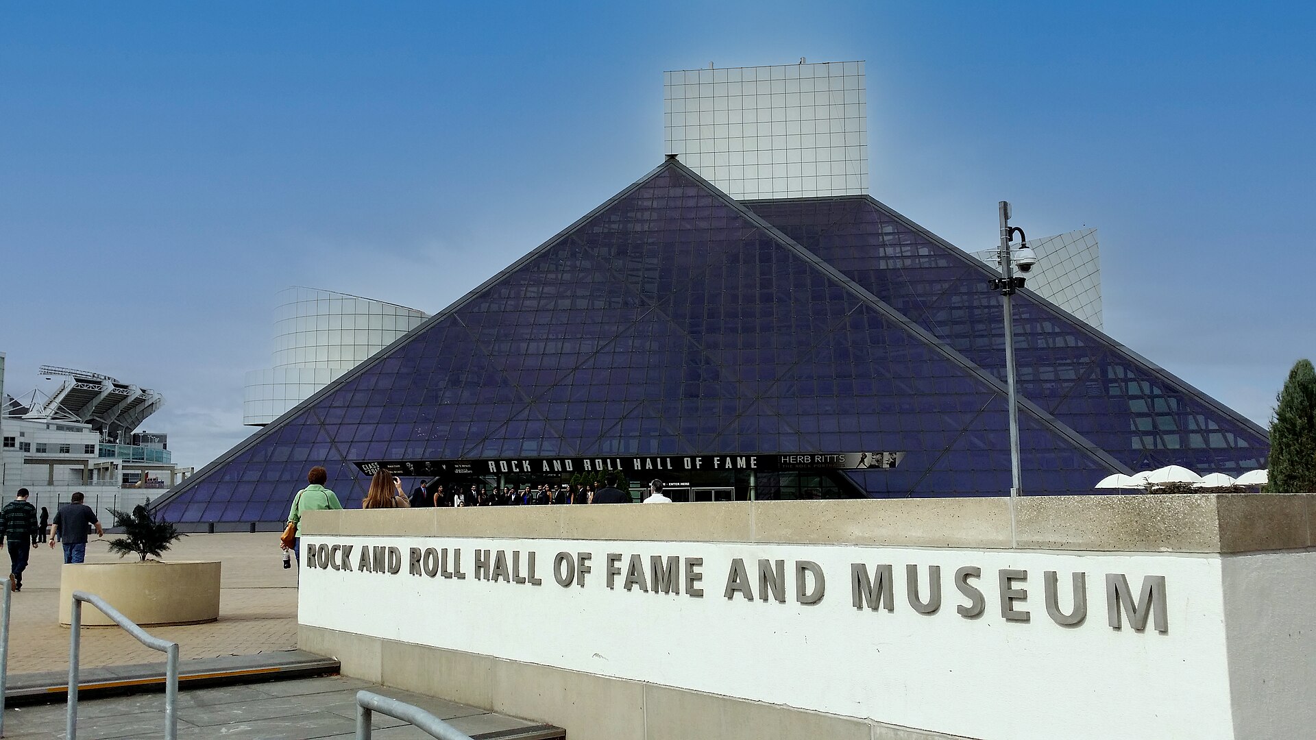 Cleveland's Rock and Roll Hall of Fame rises beside Lake Erie under a clear sky