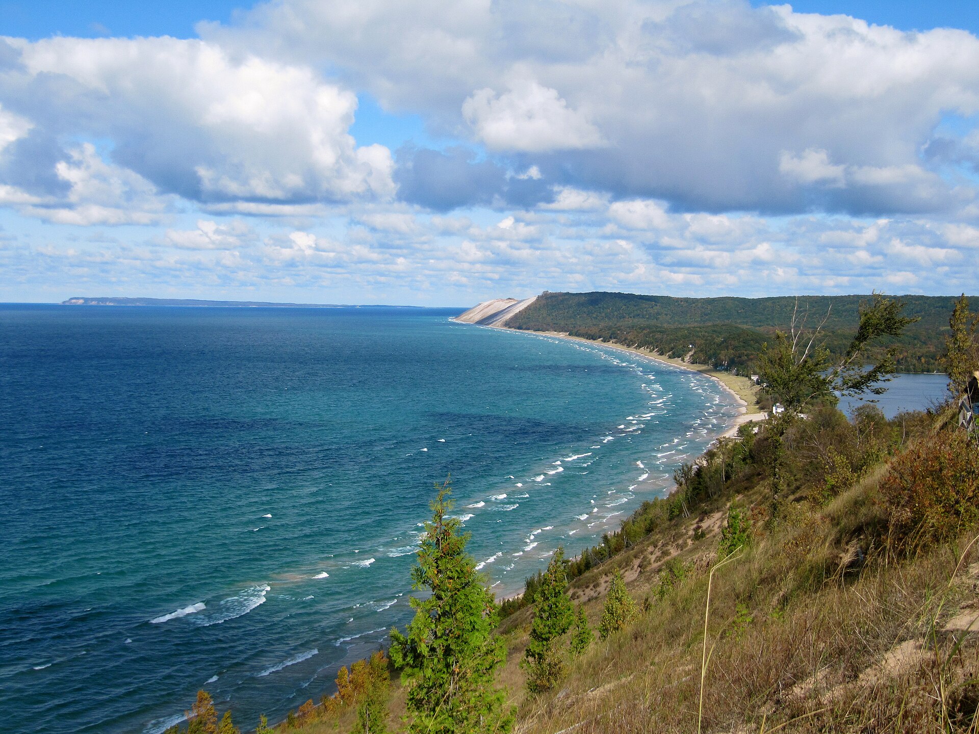 A high Sleeping Bear Dunes bluff overlooks the turquoise sweep of Lake Michigan and forested shoreline
