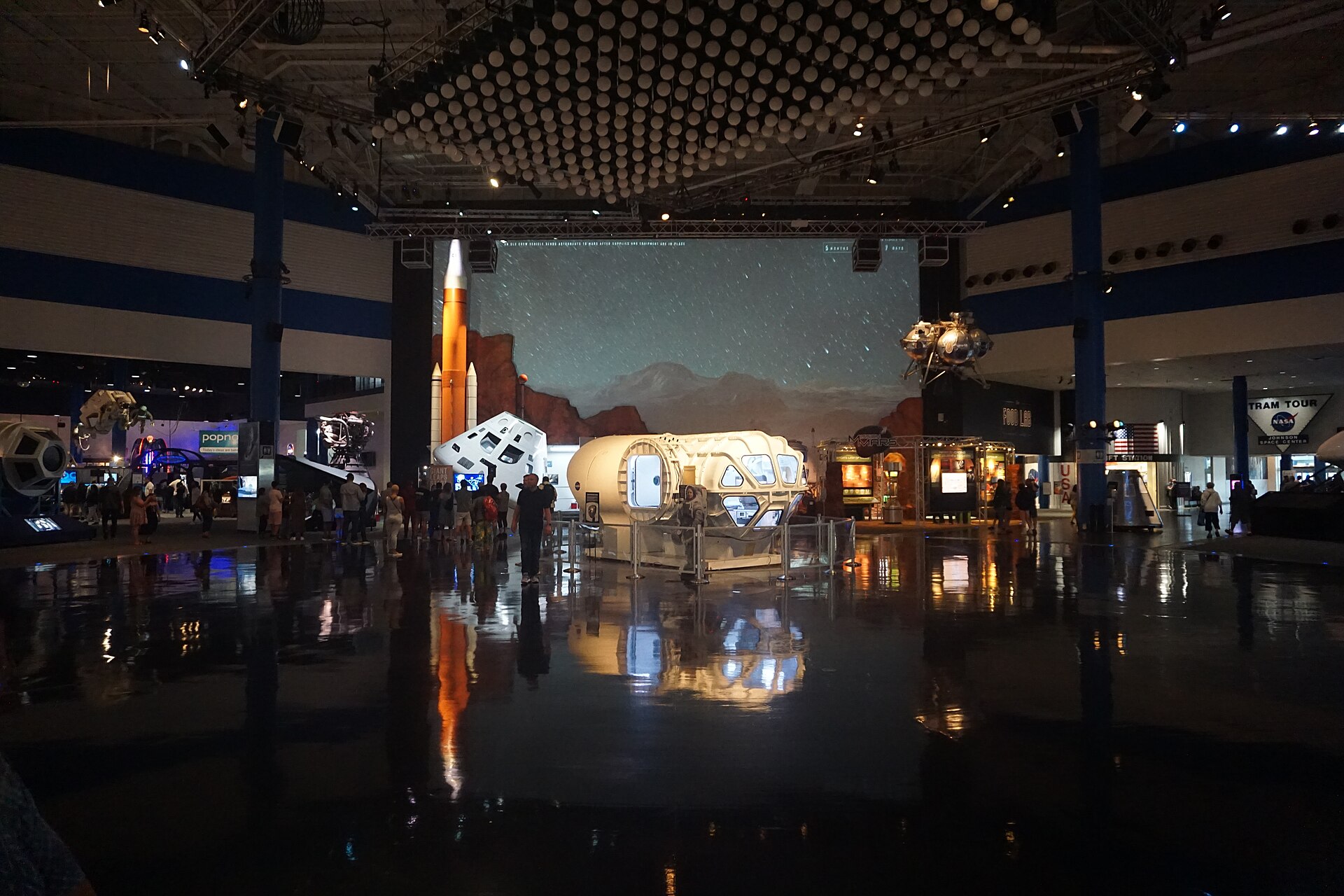 Visitors exploring spacecraft and exhibits inside Space Center Houston