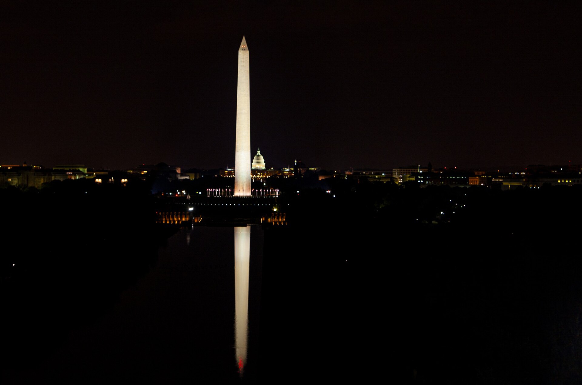 Reflecting Pool and Washington Monument illuminated at night from the Lincoln Memorial