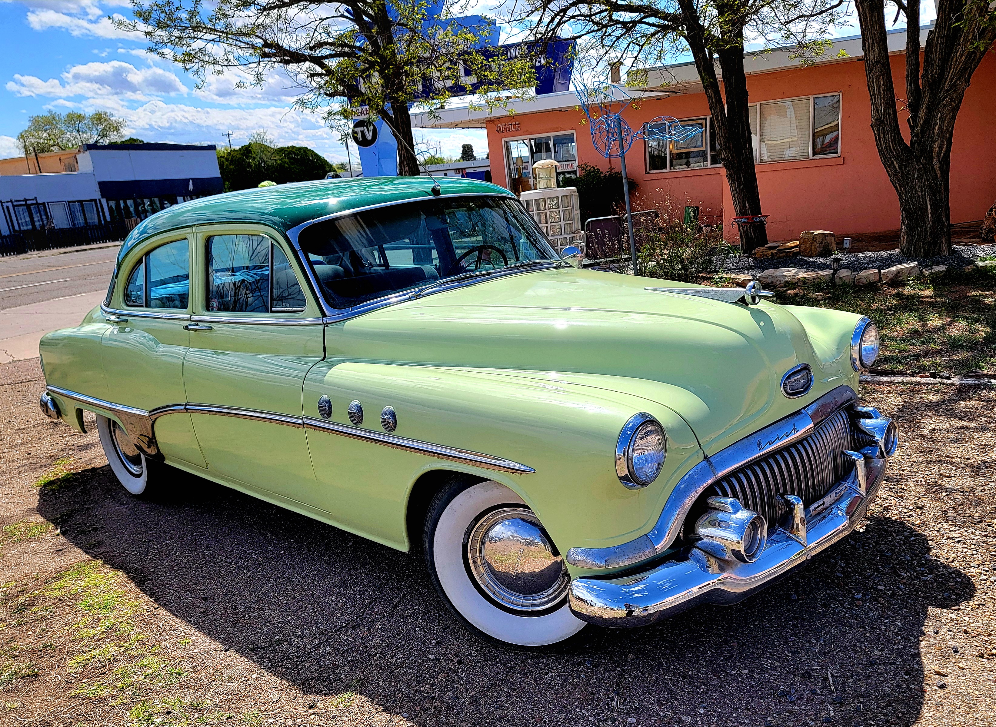 A restored Buick stands in the colorful courtyard of Tucumcari's Blue Swallow Motel