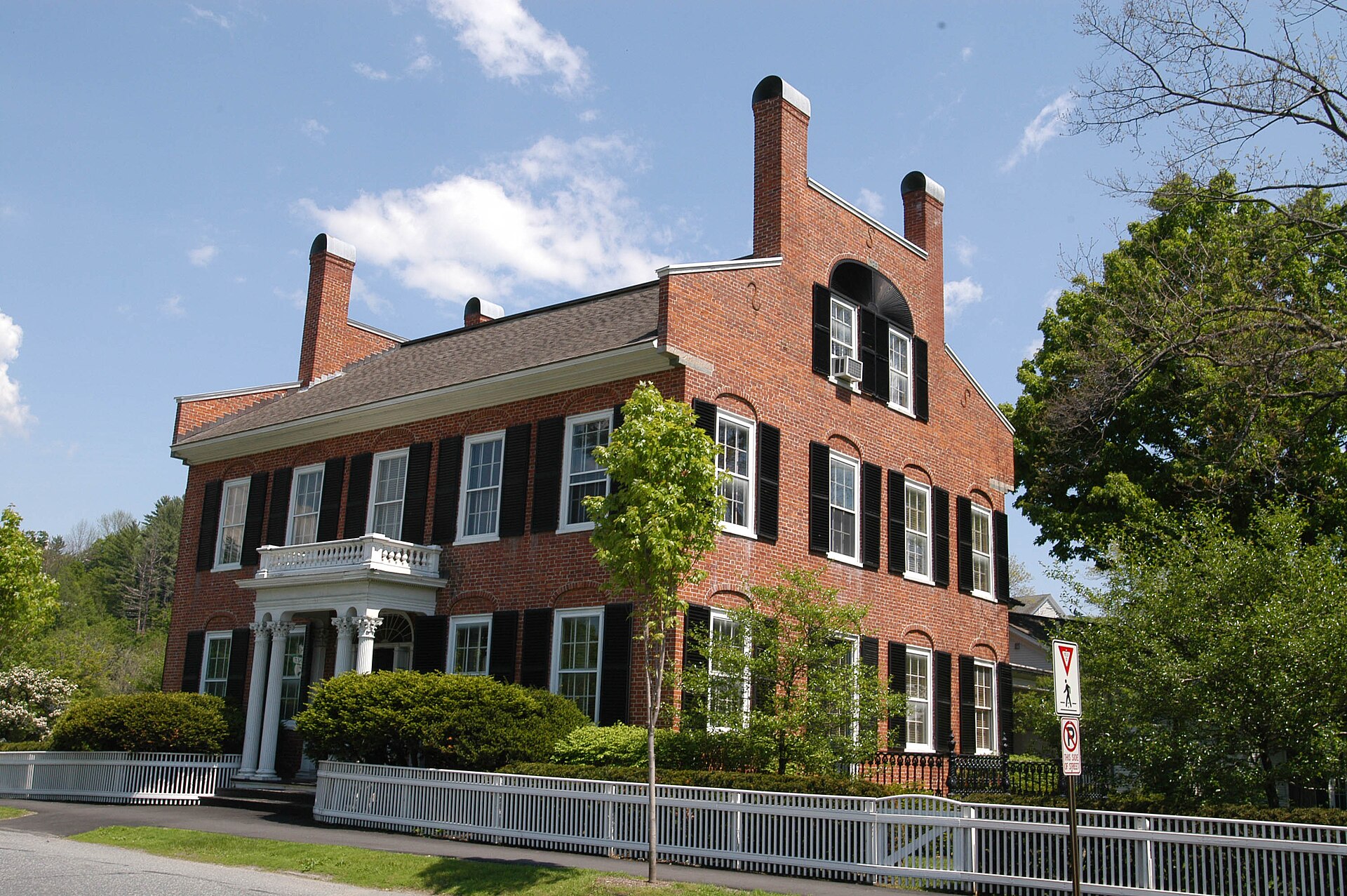 Historic red-brick house with black shutters in Woodstock, Vermont