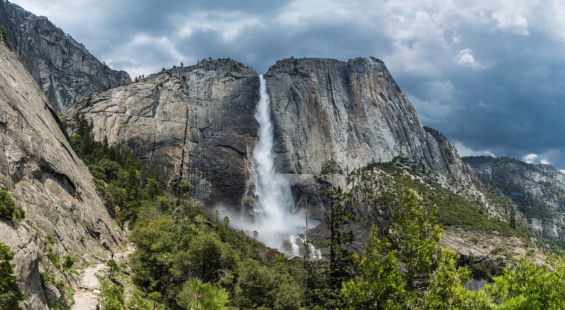 Hikers' trail view toward Yosemite Falls above the forested valley
