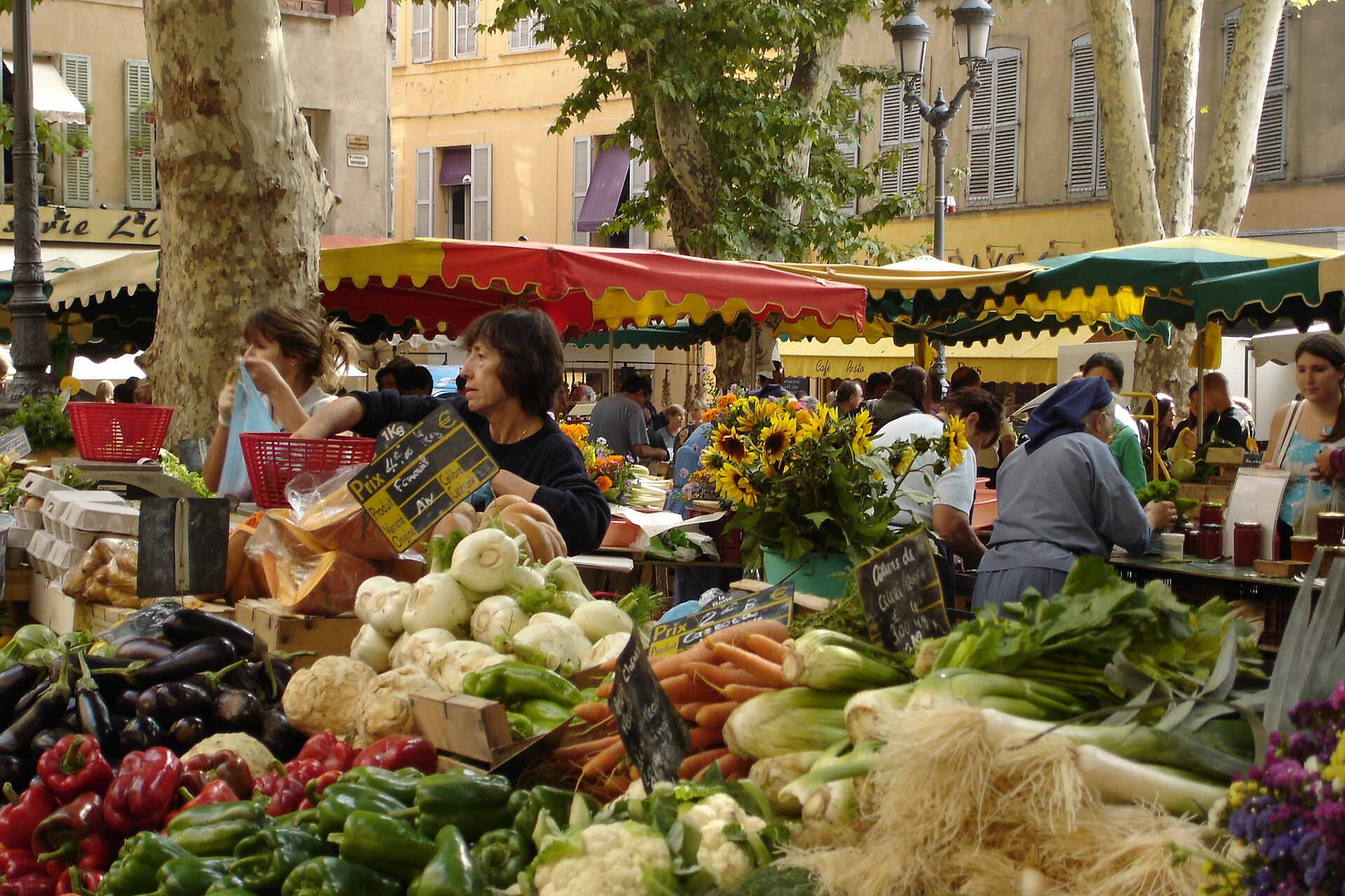 Produce vendors and shoppers at the Richelme market in Aix-en-Provence