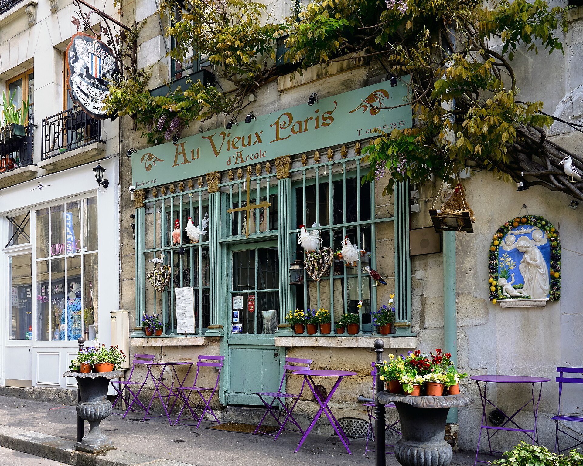 Paris cafe terrace and flowering facade near Notre-Dame