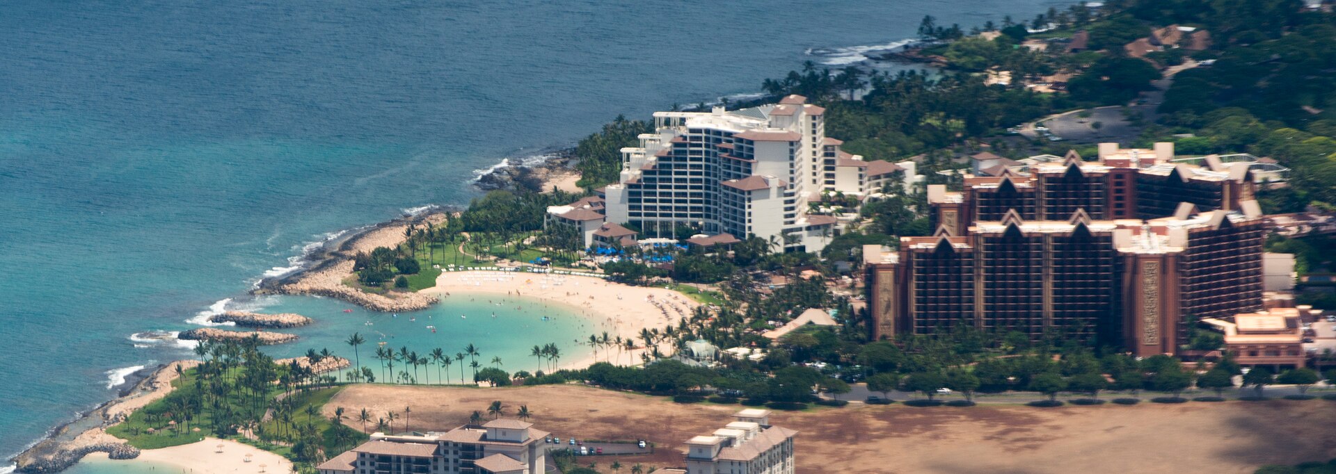 Ko Olina lagoon, beach activity, and resort buildings on Oahu