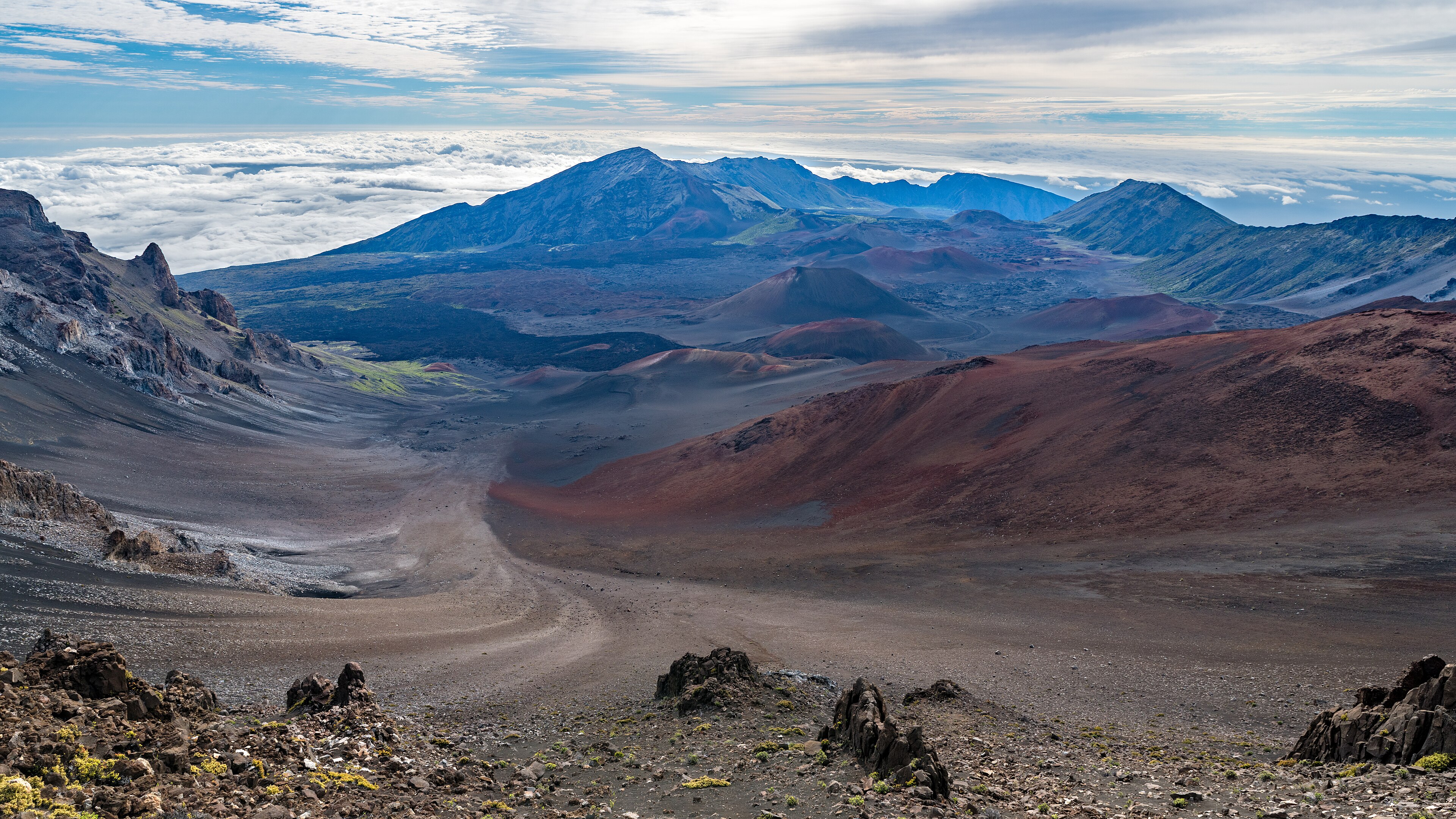 Volcanic cones and cloud layers inside Haleakala crater on Maui