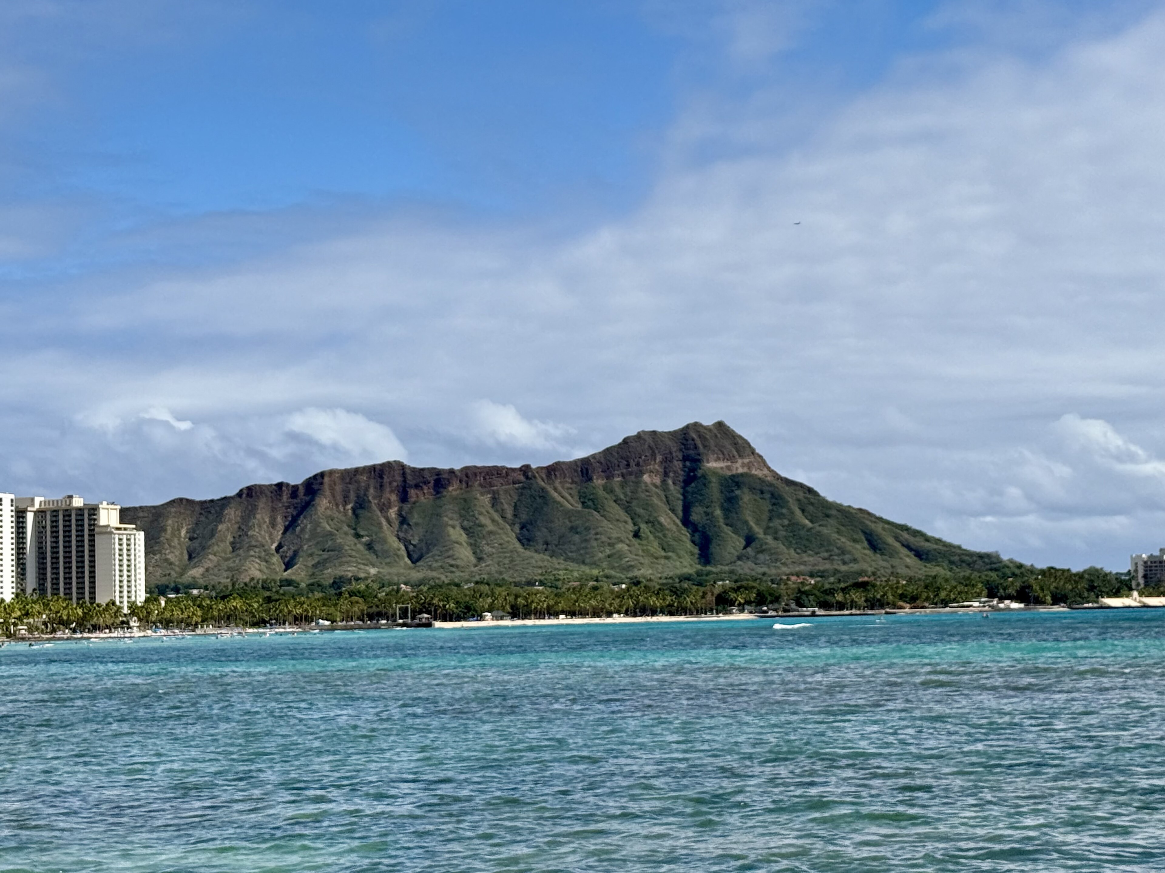 Diamond Head rising behind Waikiki's turquoise shoreline and Honolulu hotels on Oahu
