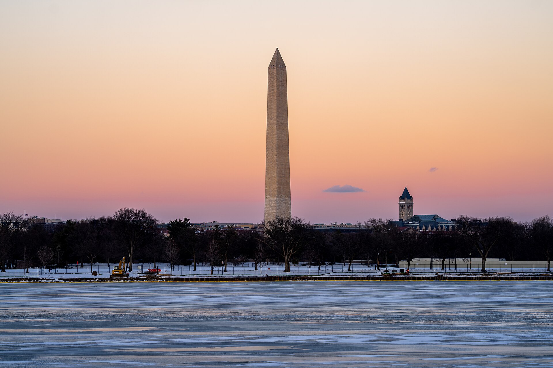 Washington Monument reflected in the icy Tidal Basin at winter sunset