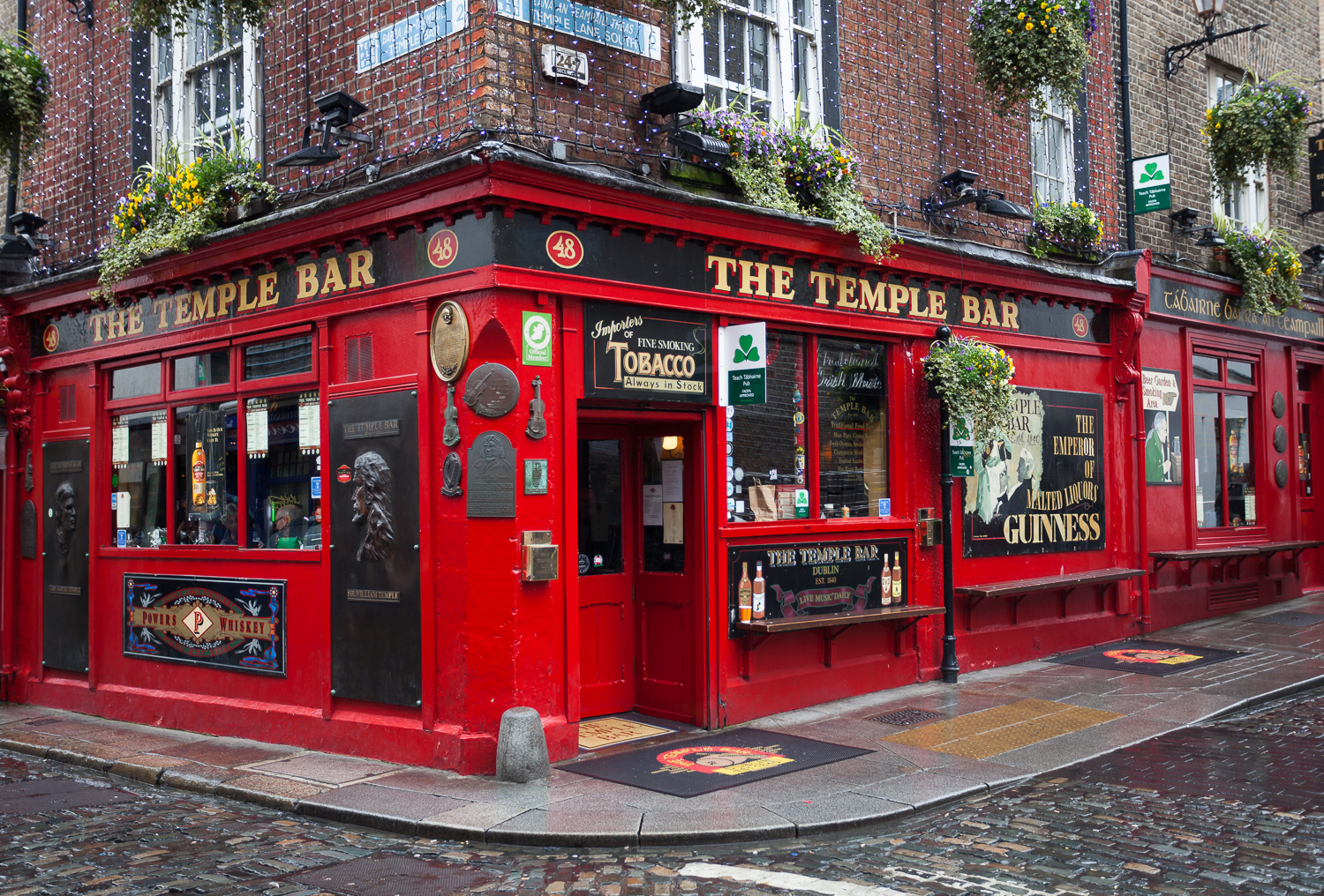 The bright red Temple Bar pub on a flower-lined Dublin street