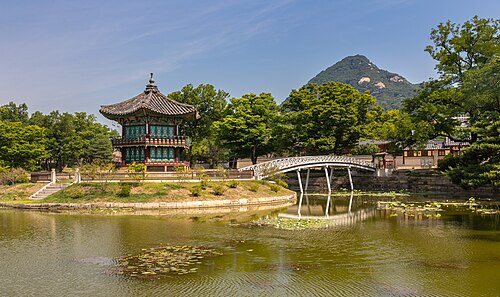 Essential city highlights for Seoul: Hyangwonjeong Pavilion and Chwihyanggyo Bridge at Gyeongbokgung Palace with blue sky in Seoul