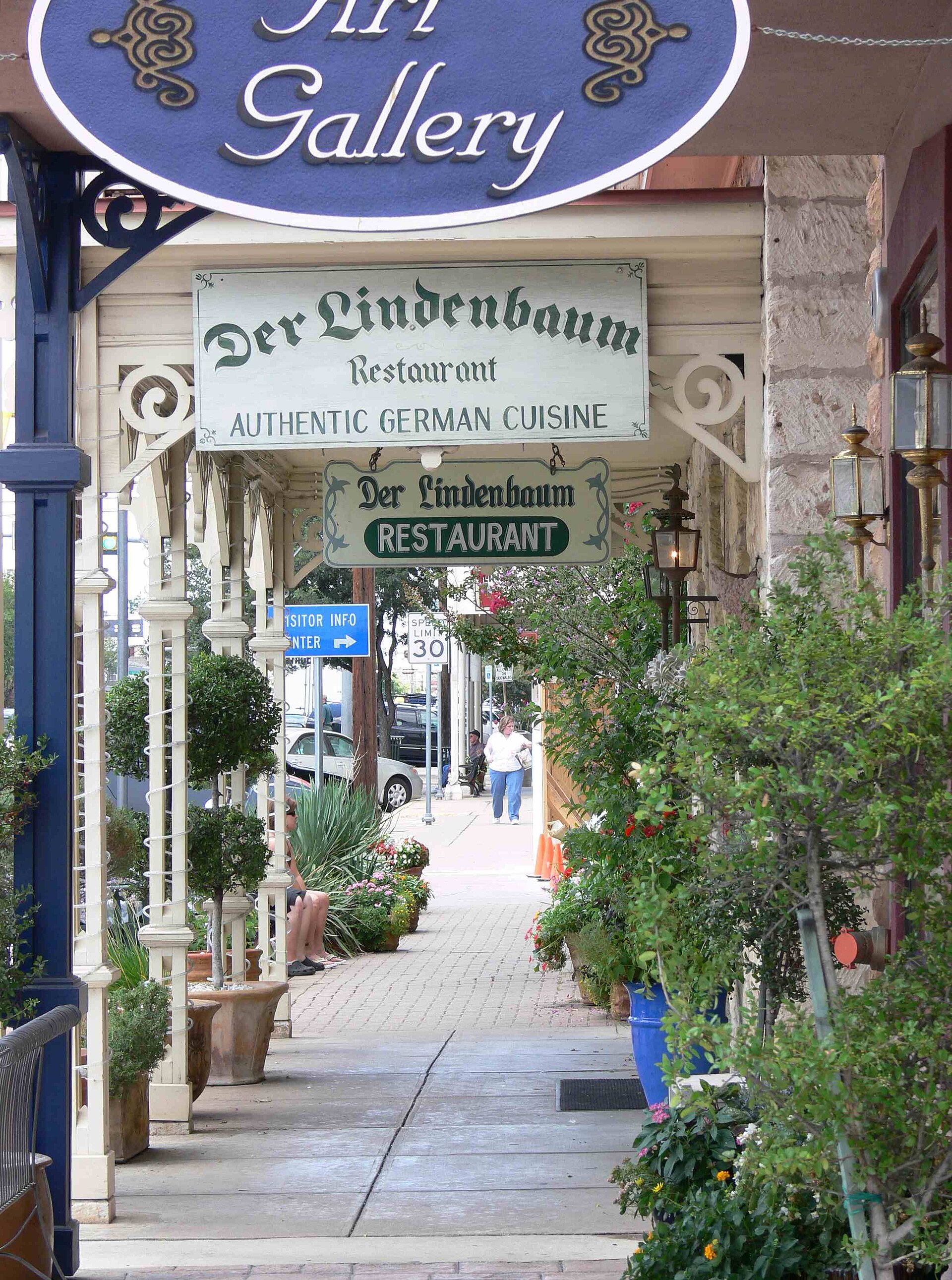Historic storefronts, restaurants, and pedestrians on Fredericksburg Main Street