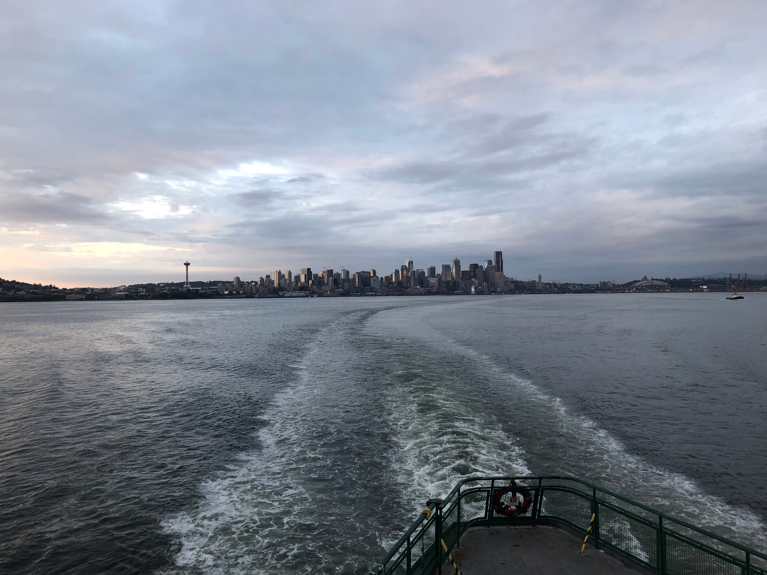 Downtown Seattle receding across Elliott Bay from a Washington ferry