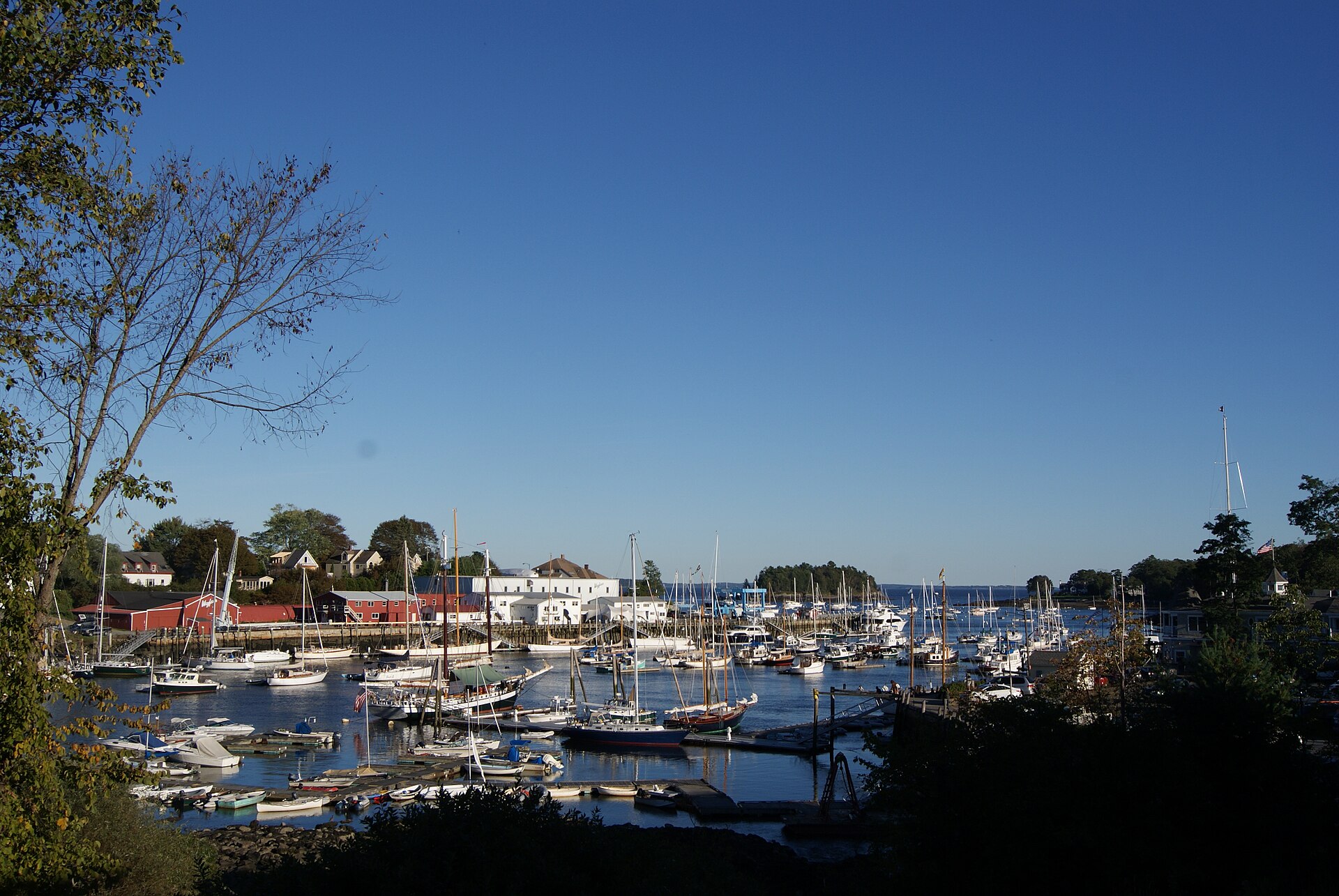 Sailboats and wooded hills surrounding Camden Harbor on the Maine coast