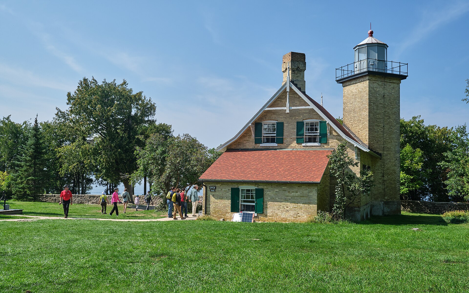 Visitors cross the lawn at Eagle Bluff Lighthouse in Door County's Peninsula State Park