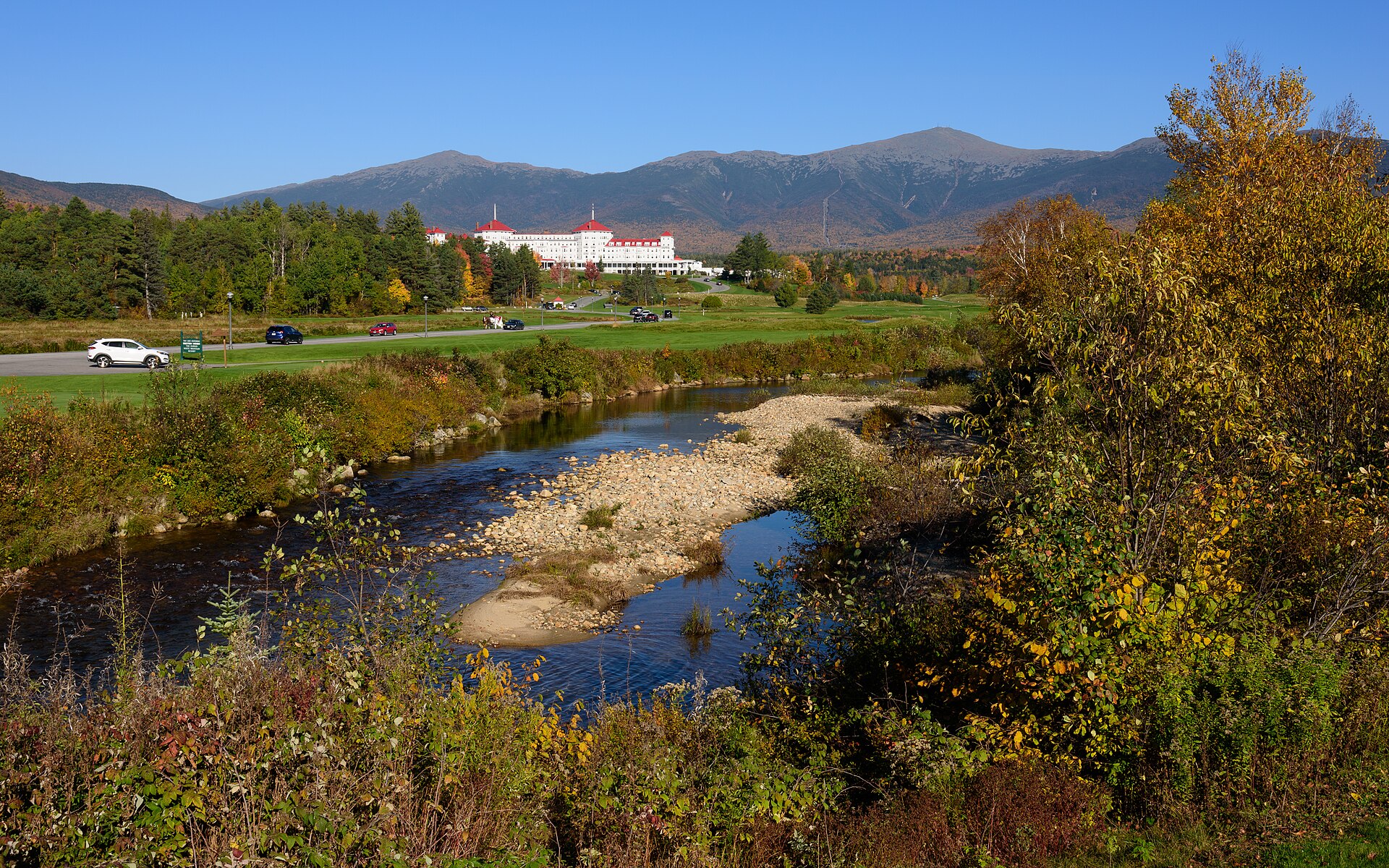 Mount Washington Hotel framed by colorful autumn forest and mountain slopes