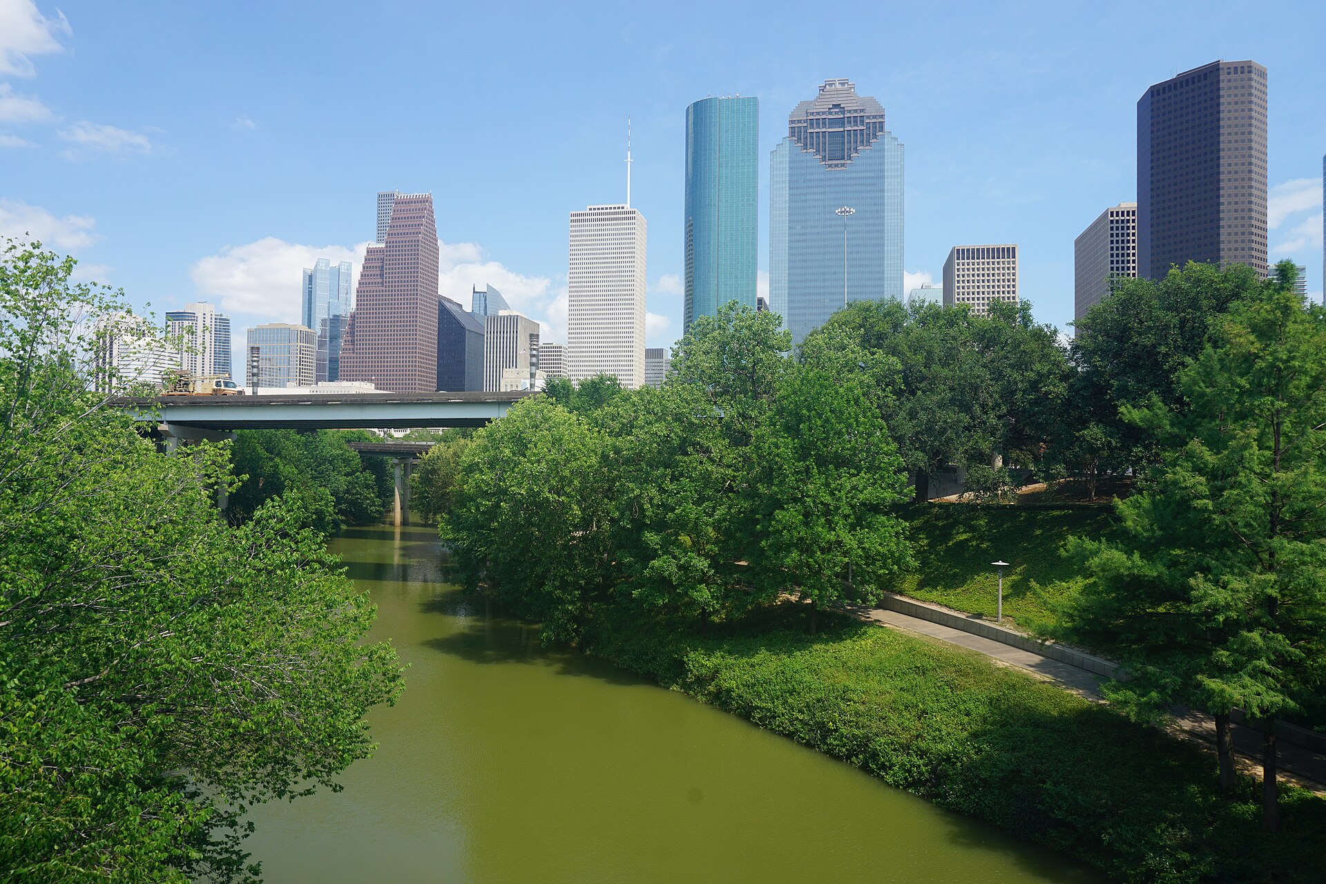 Houston's skyline rises beyond Buffalo Bayou Park at sunset