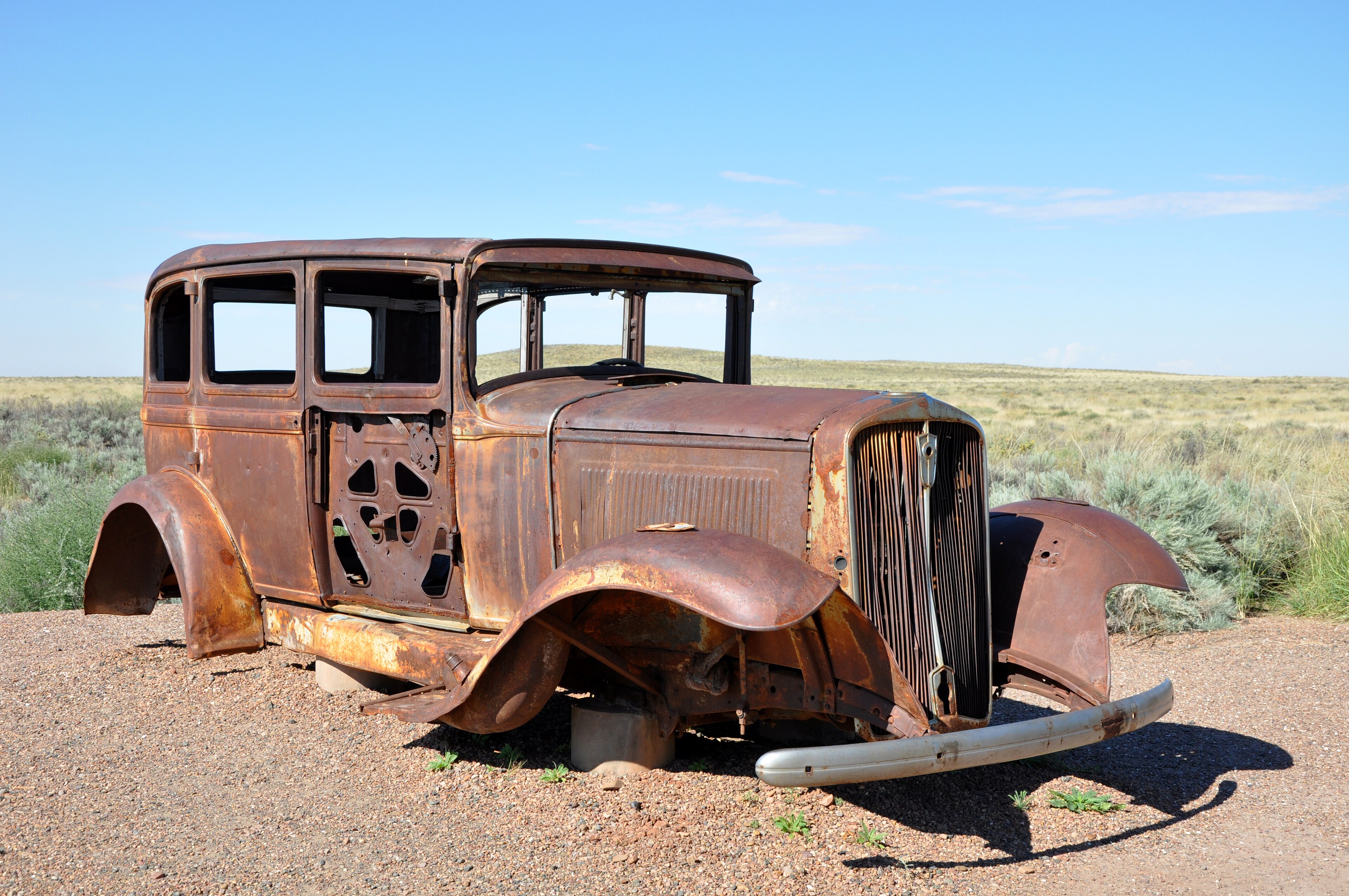 A preserved 1931 Studebaker marks the former Route 66 alignment across Petrified Forest grassland