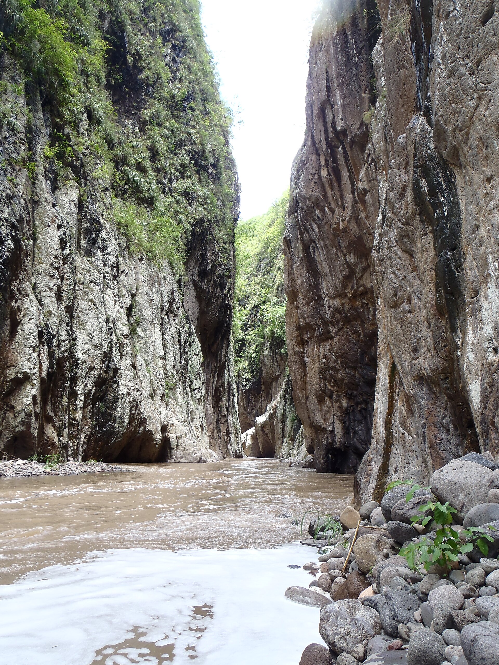 Travelers moving through the water and cliffs of Somoto Canyon