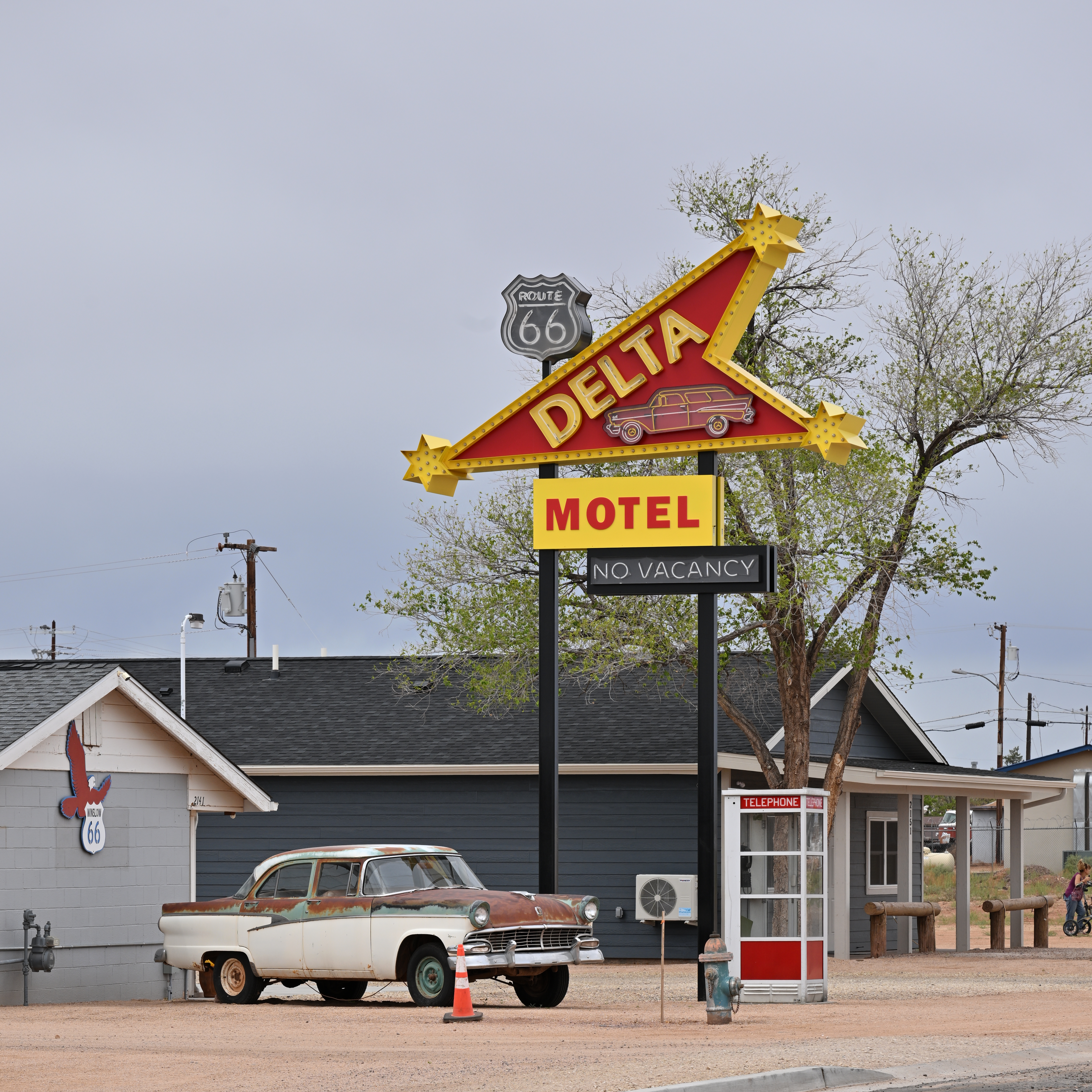 A restored Route 66 motel sign and vintage car in Winslow, Arizona