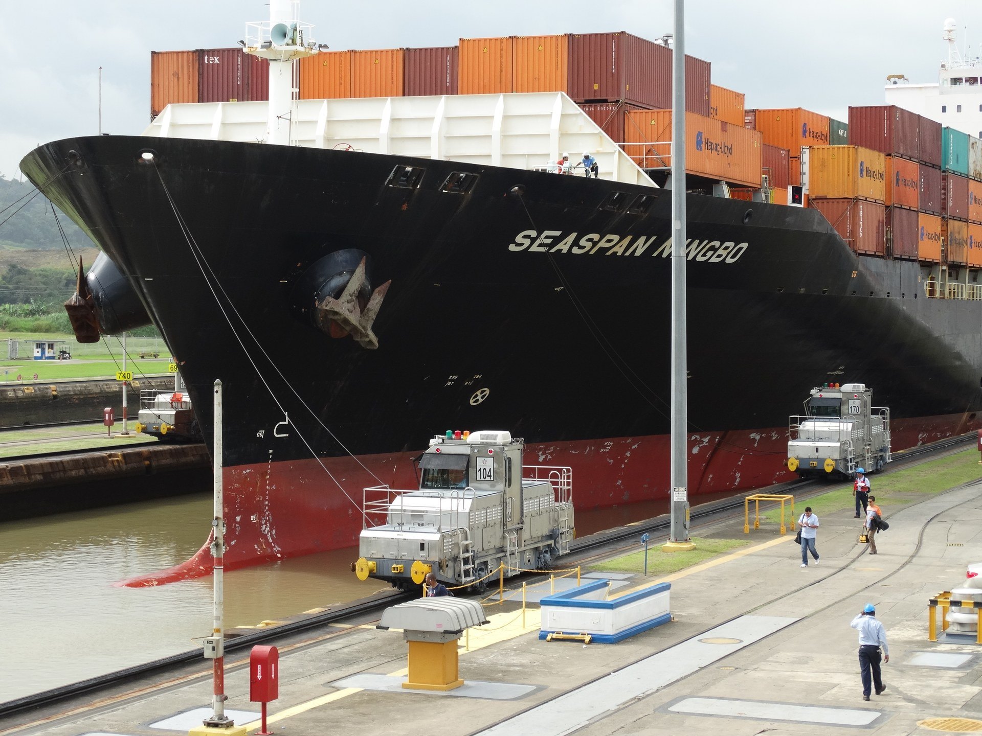 Container ship and towing locomotives operating in Miraflores Locks on the Panama Canal