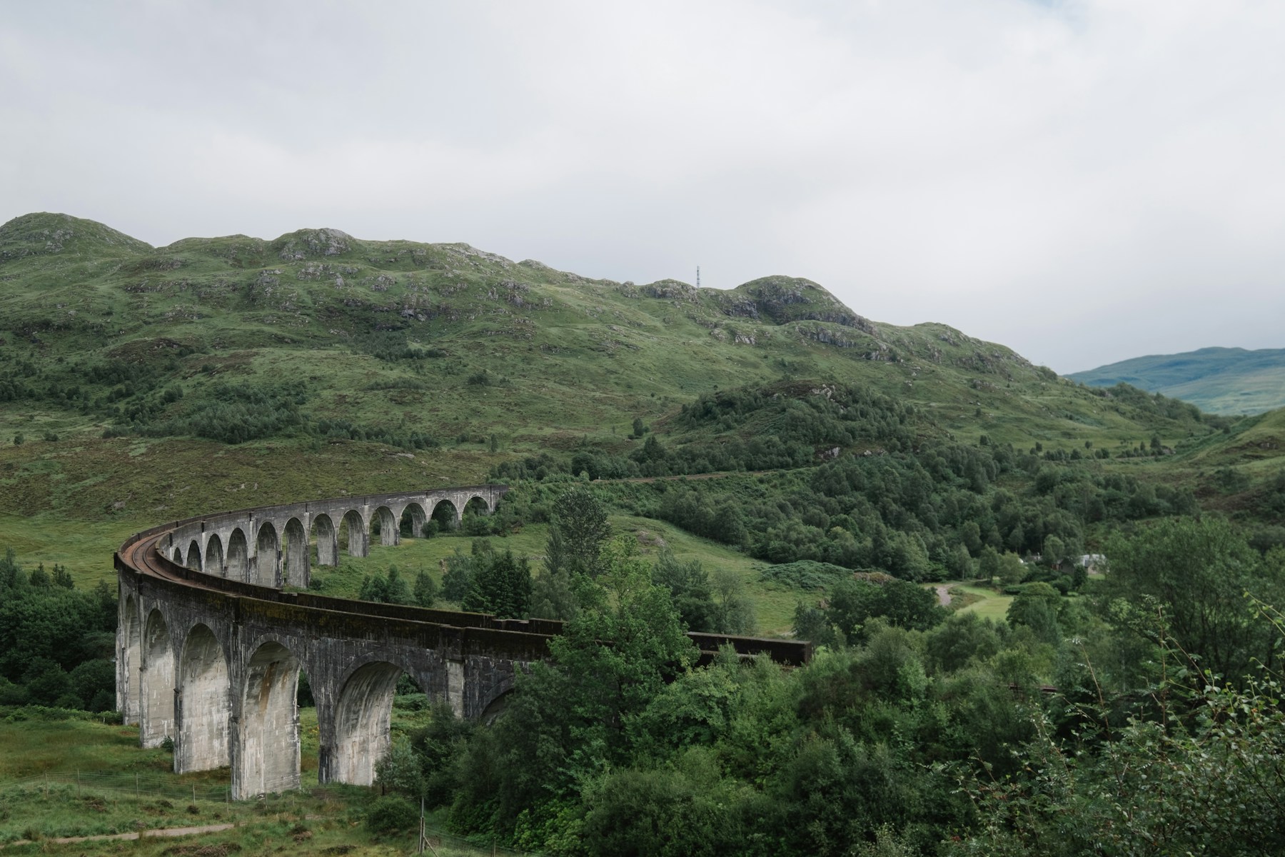 Glenfinnan Viaduct curving through the green Scottish Highlands