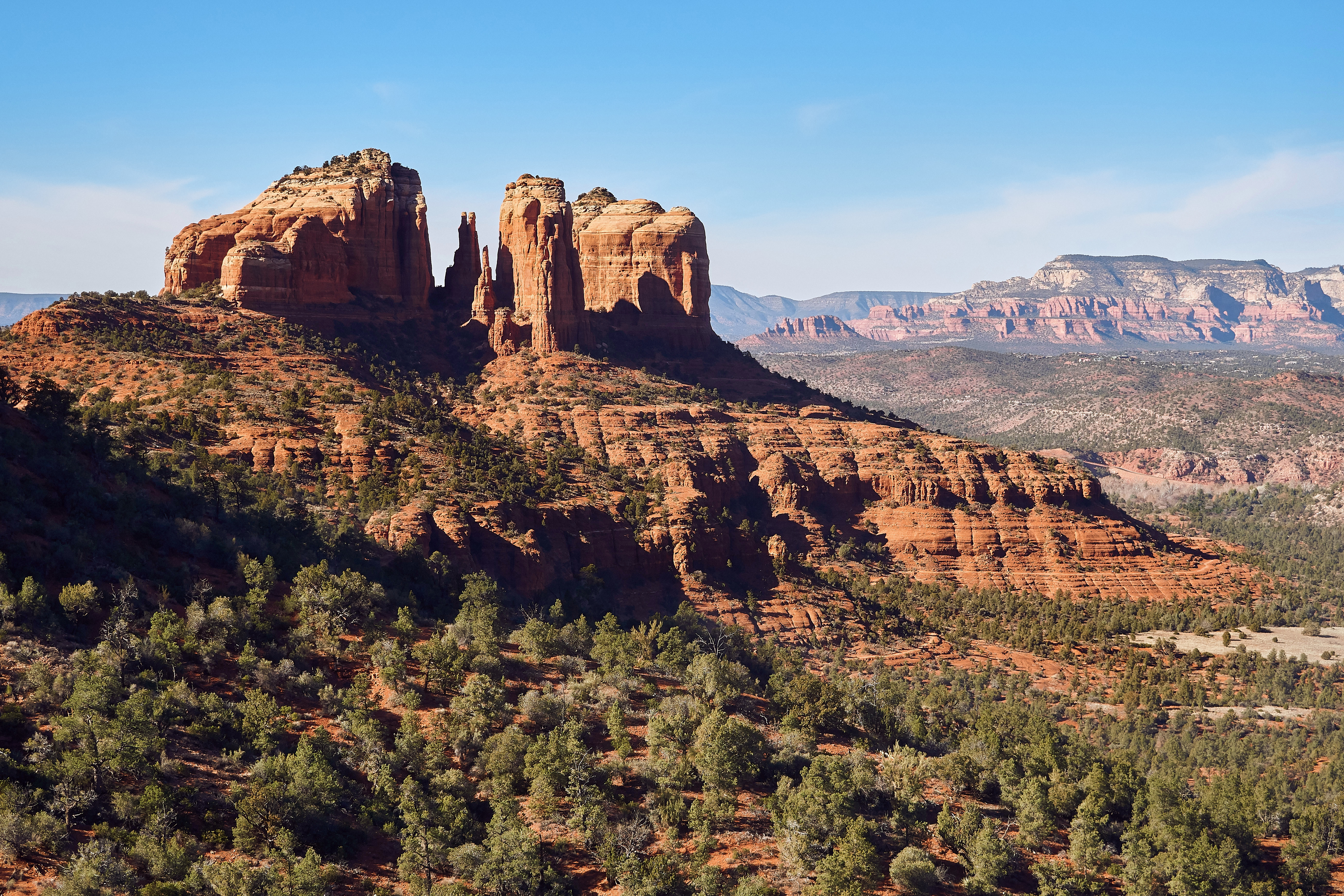 Cathedral Rock rising above the red sandstone ridges and high-desert forest of Sedona