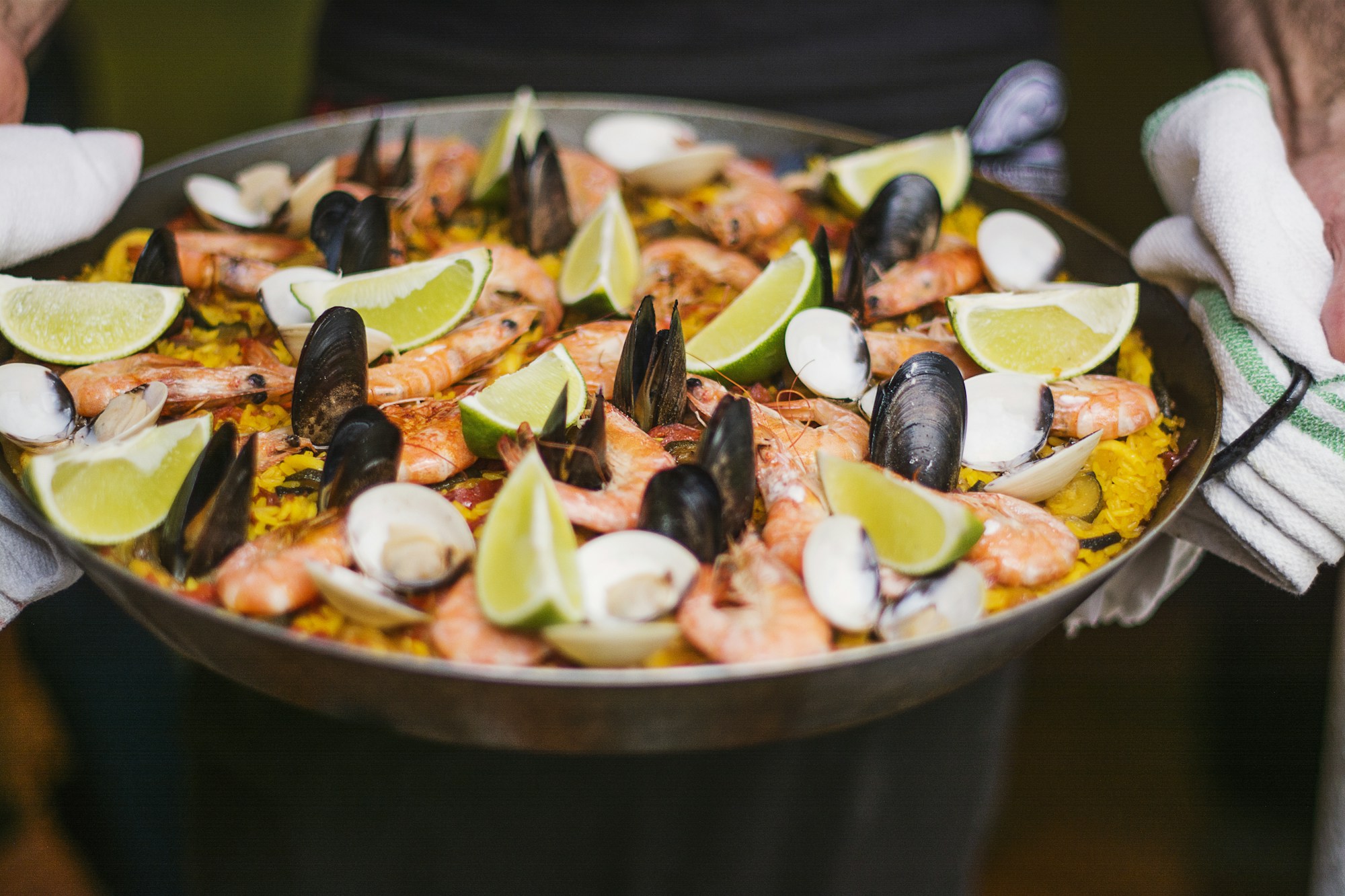 A generous pan of Spanish seafood paella prepared for a shared meal