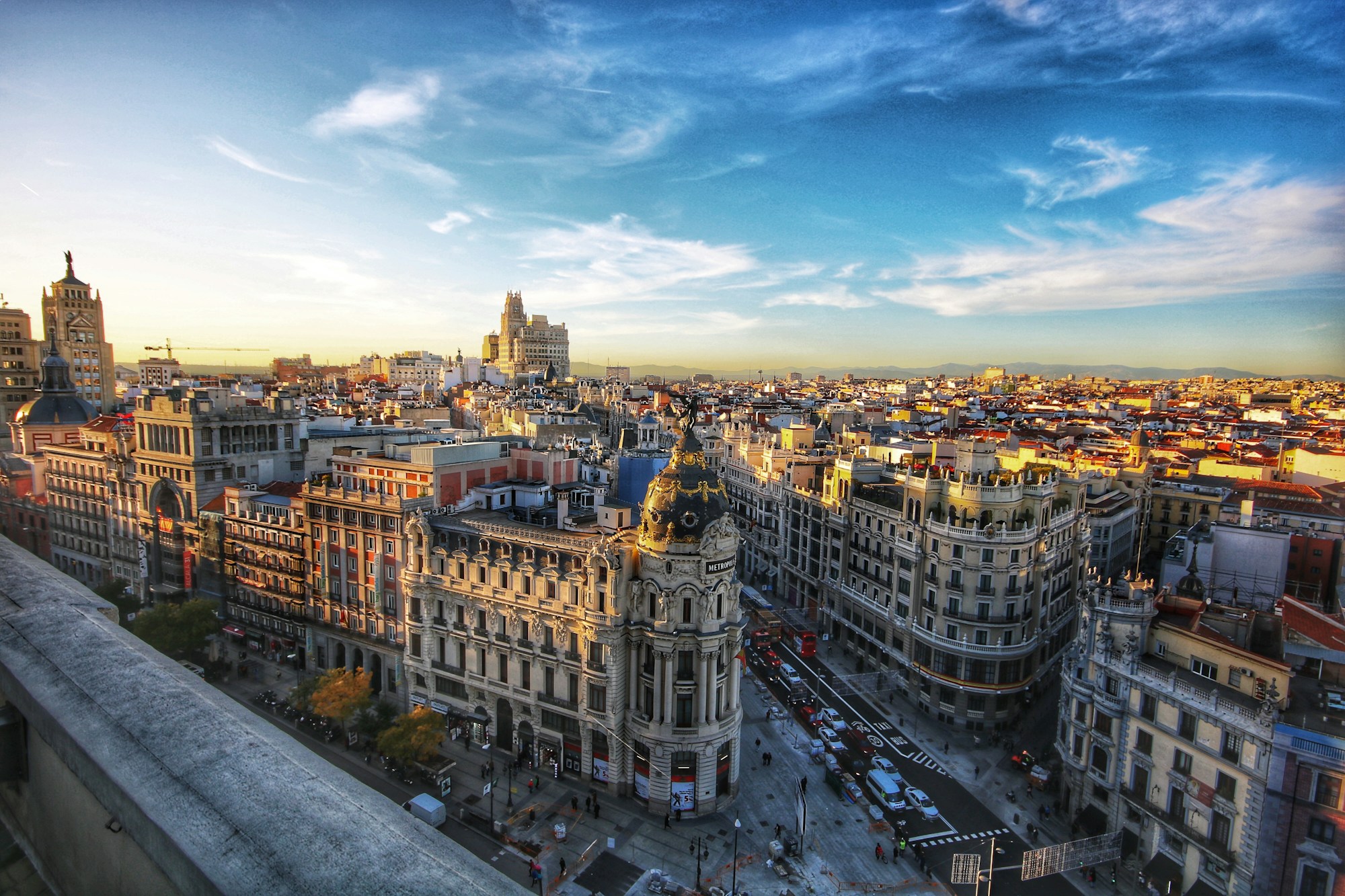 Madrid's Gran Via and Metropolis Building beneath a wide blue sky